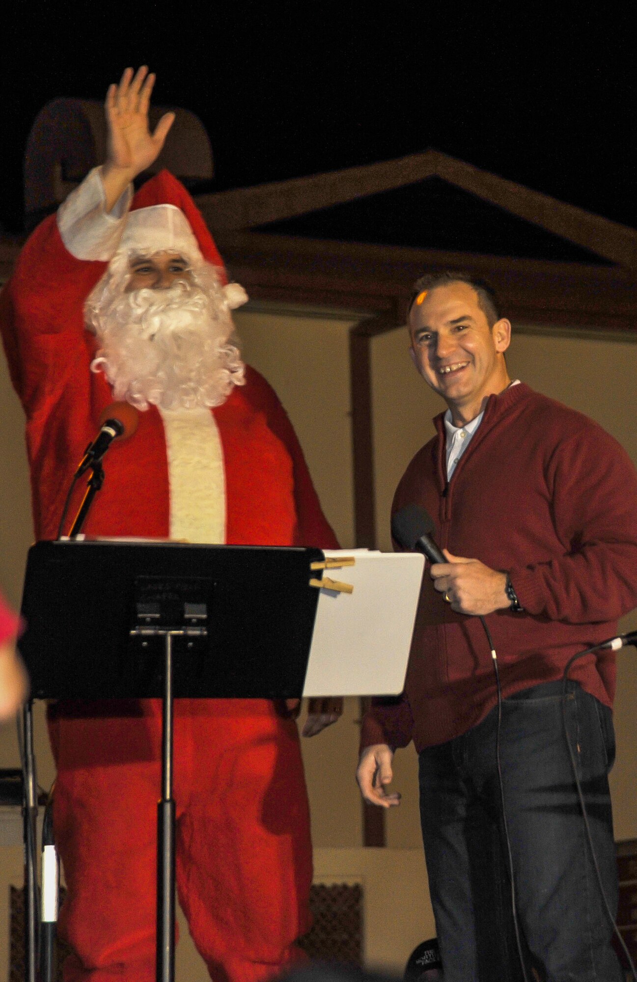 Col. Chris Bargery, 65th Air Base Wing commander, introduces the evening's special guest, Santa Claus, played by Staff Sgt. Paul Couch, 65th Air Base Wing command chief executive, as he  greets Team Lajes families during The Polar Express Dec. 8. More than 300 family members watched "The Polar Express" movie, enjoyed a simulated train ride through a Winter Wonderland and ended the night with a holiday tree lighting ceremony on Lajes. This was the kickoff to a series of December holiday events on Lajes. (U.S. Air Force photo by Staff Sgt. Angelique N. Smythe) 