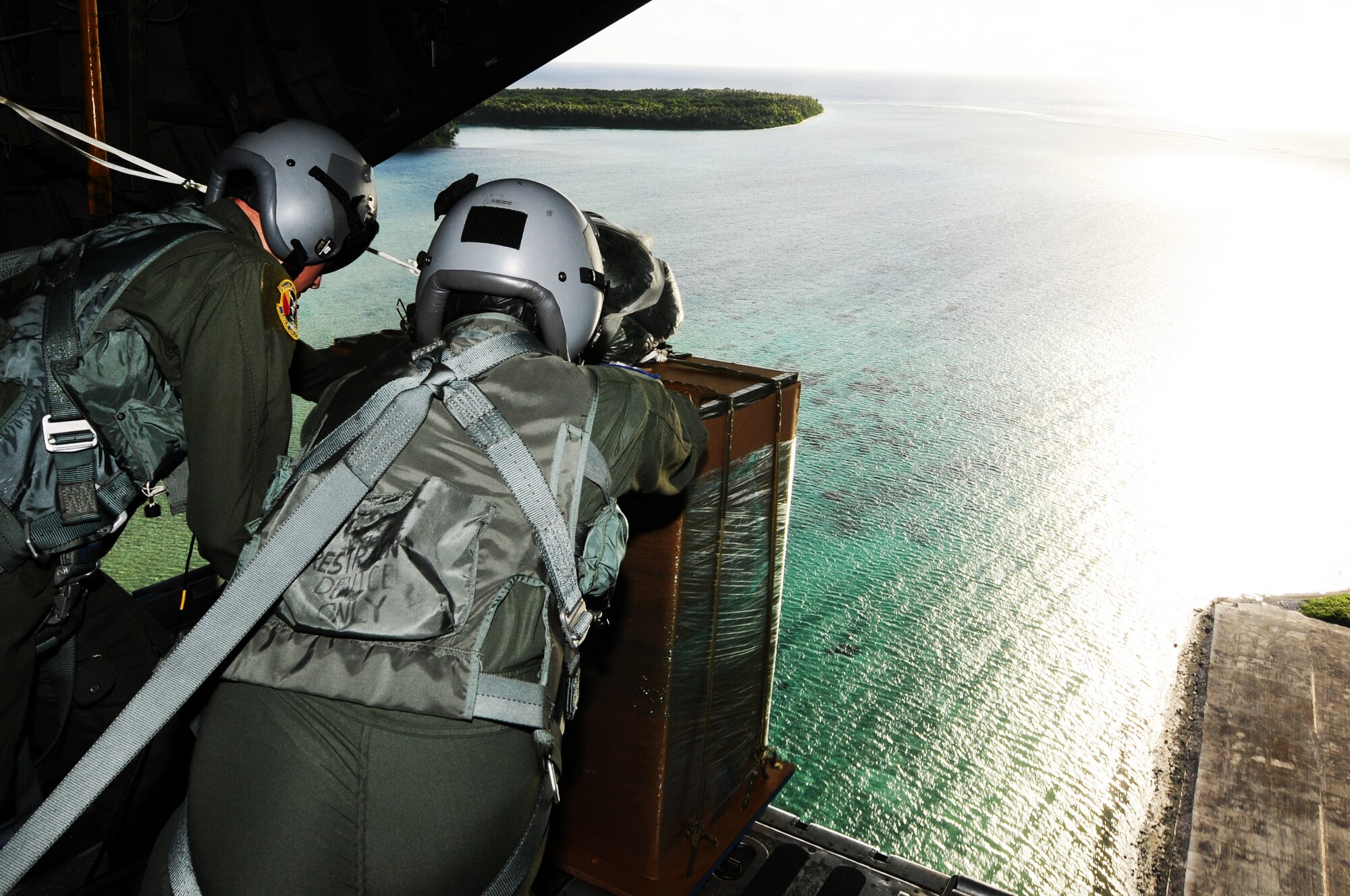 C-130 loadmasters from the 36th Airlift Squadron, Yokota Air Base, Japan, begin air drop delivery of a pallet over Mokil Island as part of Operation Christmas Drop 2012, Dec. 12, 2012. Each year OCD provides aid to more than 30,000 islanders in Chuuk, Palau, Yap, Marshall Islands and Commonwealth of the Northern Mariana Islands. This year is the 61st anniversary of OCD, making it the longest running humanitarian mission in the world. In total, there are eight planned days of air drops, with 54 islands scheduled to receive humanitarian aid. (U.S. Air Force photo by Senior Airman Carlin Leslie/Released)