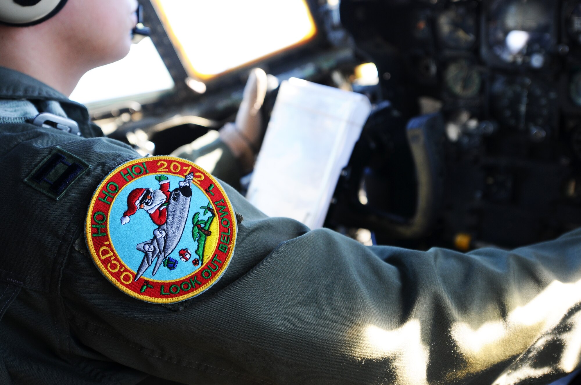 The Operation Christmas Drop 2012 patch is displayed on the arm of Capt. Anthony Felix, an instructor pilot from the 36th Airlift Squadron at Yokota Air Base, Japan, as he takes off to begin an OCD delivery flight from Andersen Air Force Base, Guam, Dec. 12, 2012.  Each year OCD provides aid to more than 30,000 islanders in Chuuk, Palau, Yap, Marshall Islands and Commonwealth of the Northern Mariana Islands. This year is the 61st anniversary of OCD, making it the longest running humanitarian mission in the world. In total, there are eight planned days of air drops, with 54 islands scheduled to receive humanitarian aid.  (U.S. Air Force photo by Senior Airman Carlin Leslie/Released)