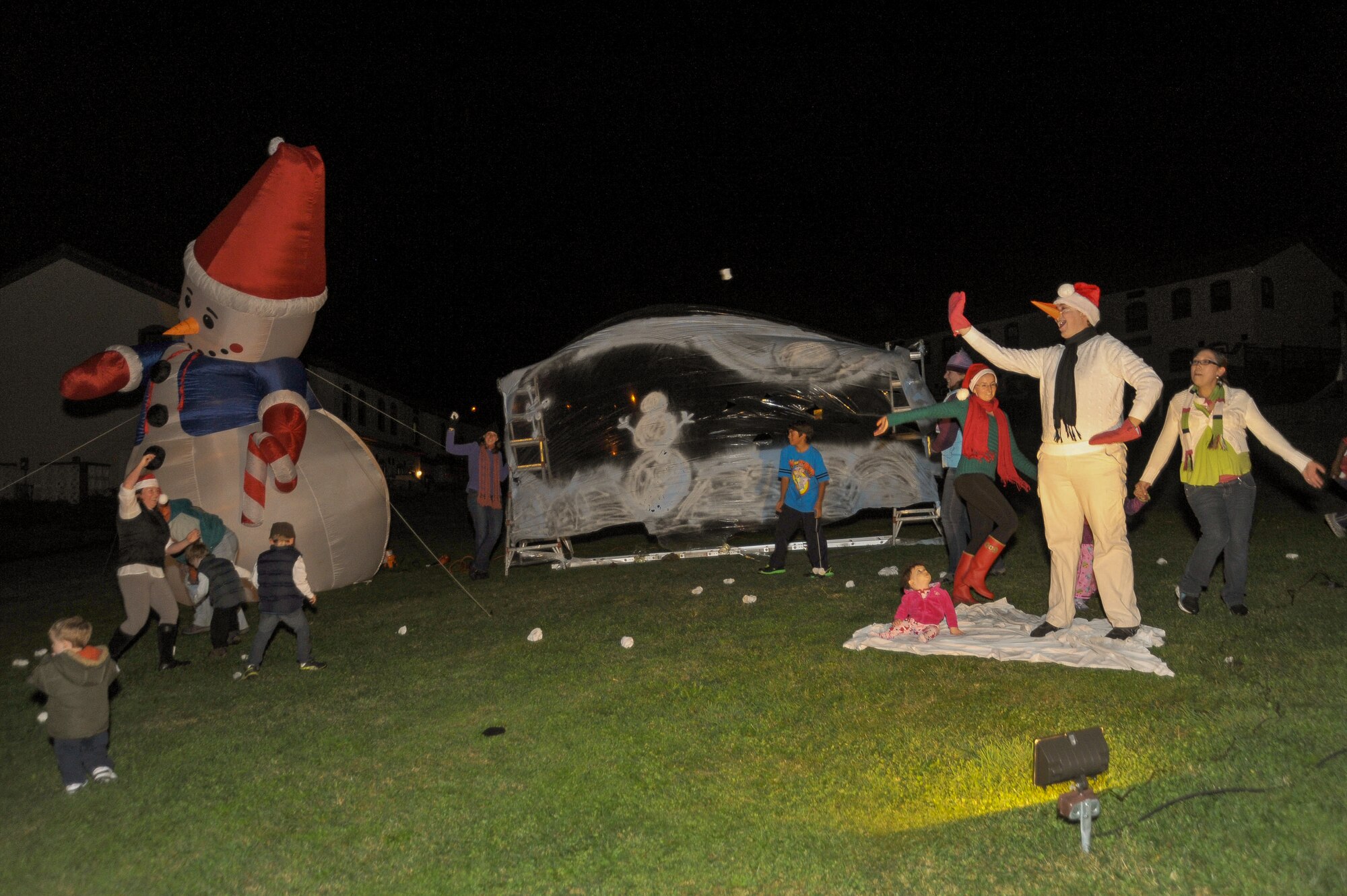 Team Lajes members participate in live action Christmas displays as families ride a simulated train through Winter Wonderland in the Nascer do Sol housing area Dec. 8. Families also watched "The Polar Express" movie at the base theater and ended the night with a holiday tree lighting ceremony on Lajes. This was the kickoff to a series of December holiday events on Lajes. (U.S. Air Force photo by Staff Sgt. Angelique N. Smythe) 
