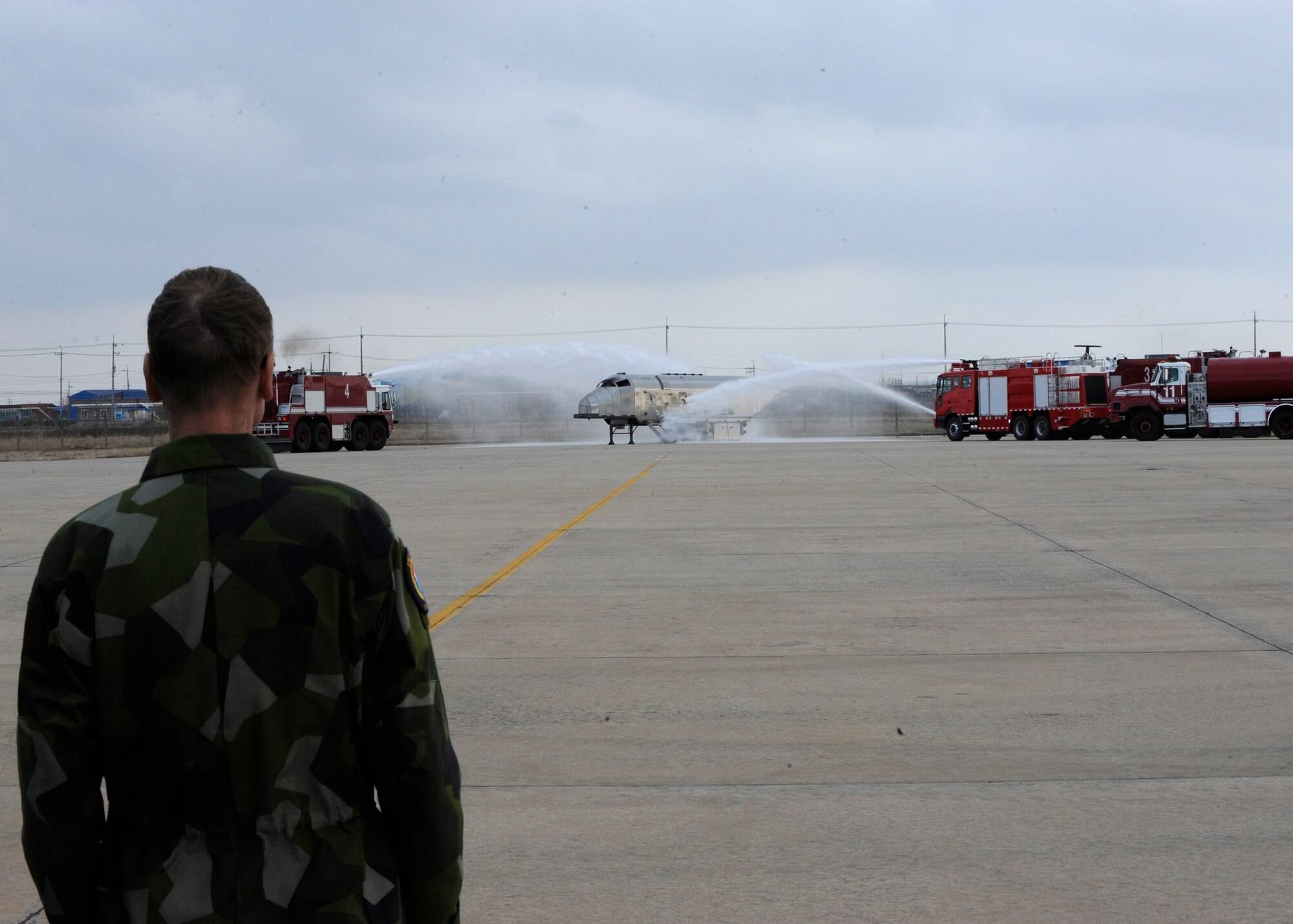 Swedish military Colonel Mikael Johnsson, Neutral Nations Supervisory Commission observes Republic of Korea Air Force and United States Air Force demonstrating their abilities to work together to put out a burning aircraft on Kunsan Air Base, Republic of Korea, Nov. 18, 2012. The NNSC is made up of five Swedish military members and five Swiss military members. (U.S. Air Force photo by Senior Airman Marcus Morris/released)