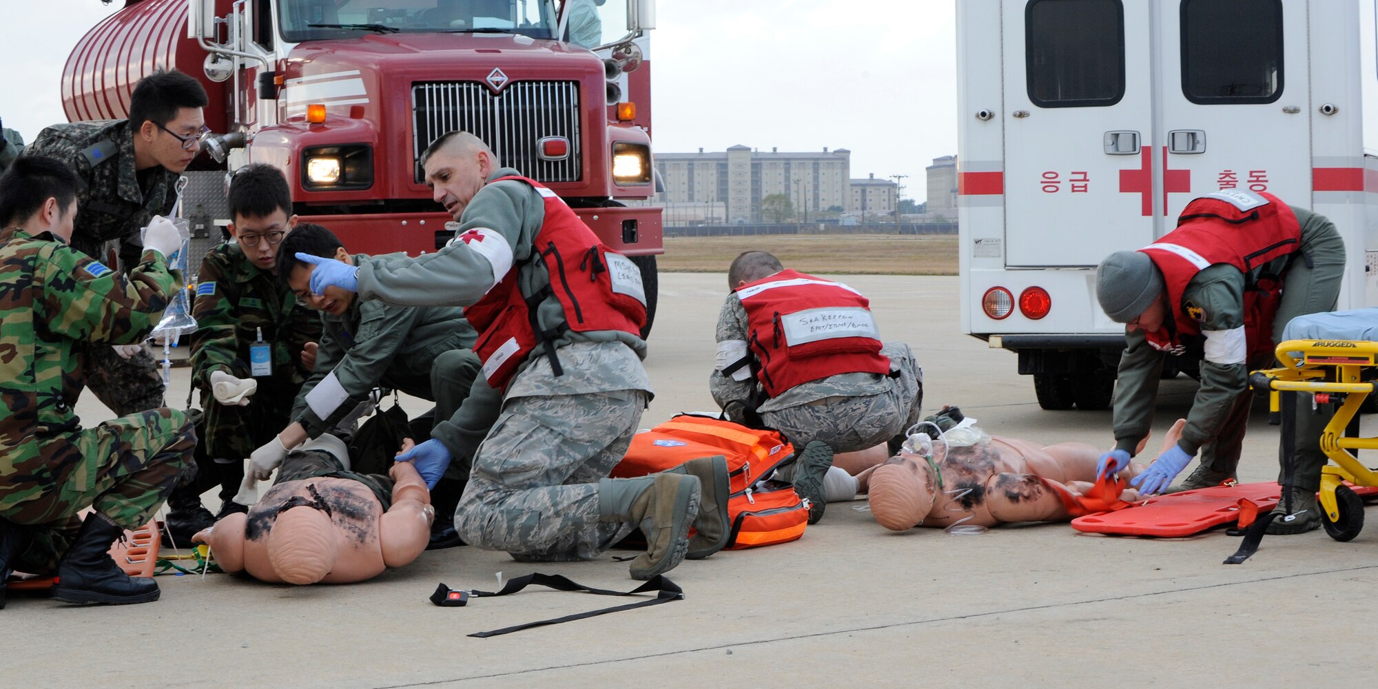 Republic of Korea Air Force and United States Air Force Airmen demonstrate to the Neutral Nations Supervisory Commission their abilities to work together to treat patients from a simulated burning aircraft on Kunsan Air Base, Republic of Korea, Nov. 18, 2012. The NNSC was originally comprised of six members from  Sweden, Switzerland, Poland and Czechoslovakia but now only five Swiss and five Swedish members remain a part of the NNSC. (U.S. Air Force photo by Senior Airman Marcus Morris/released)