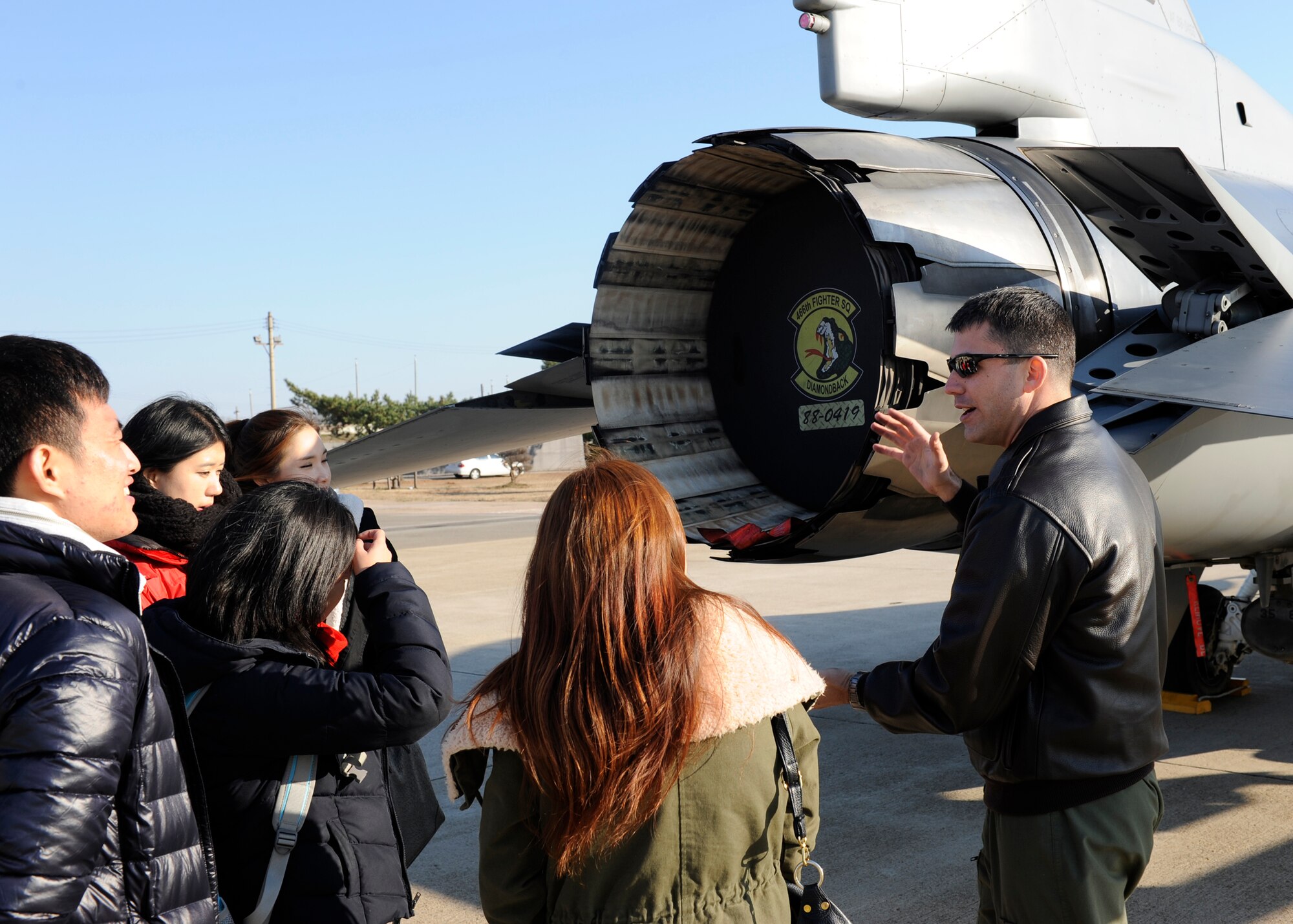 Major Nathan Smith, 35th Fighter Squadron talks to the Gunsan National University students about the F-16 Fighting Falcon during an exchange on Kunsan Air Base, Republic of Korea, Nov. 27, 2012. The exchange helps Gunsan’s younger generation build a closer relationship with Kunsan Air Base. (U.S. Air Force photo by Senior Airman Marcus Morris/released)