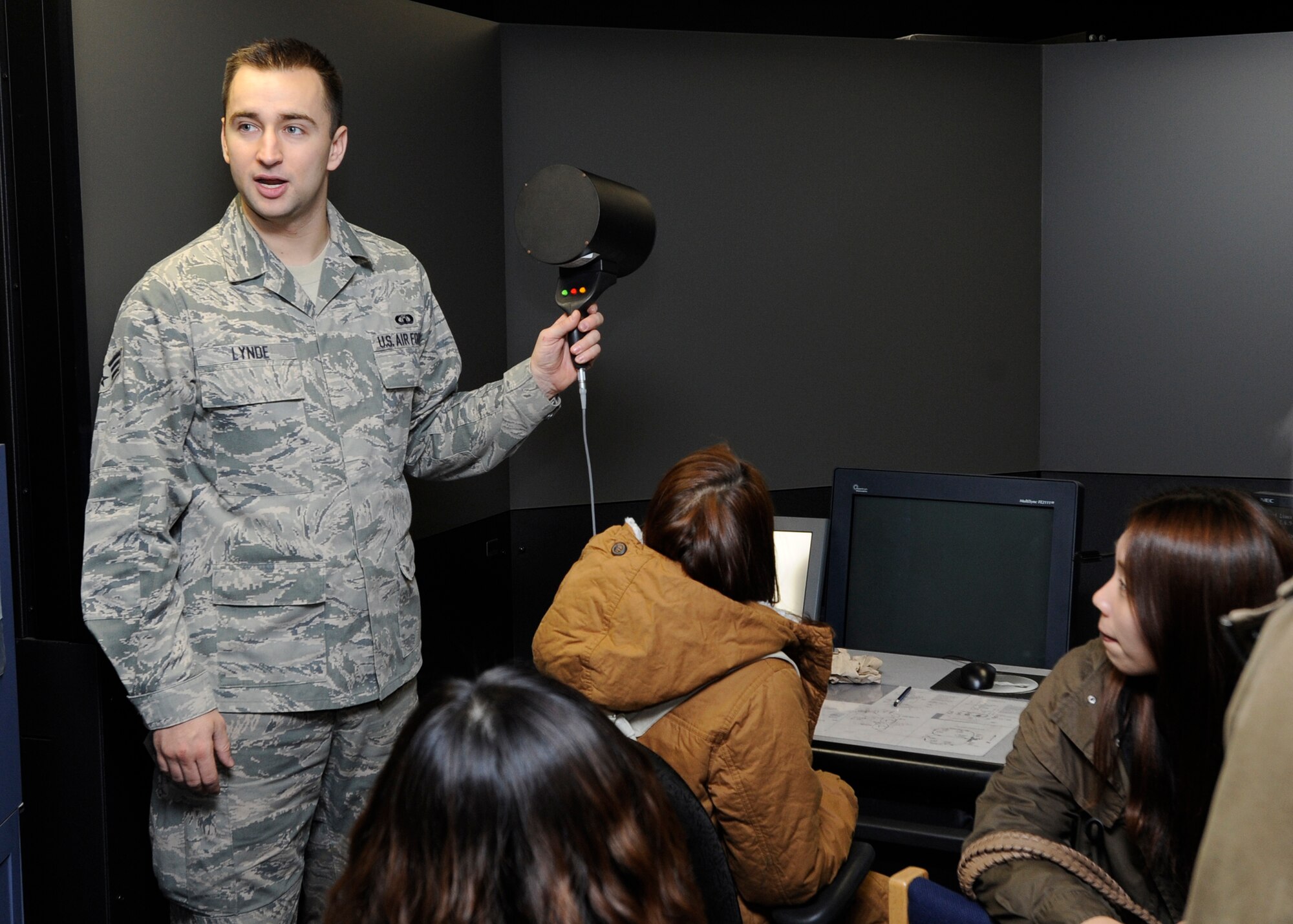 Senior Airman Aaron Lynde, 8th Operation Support Squadron air traffic controller, demonstrates to the Gunsan National University students how the tower uses the signal light gun on Kunsan Air Base, Republic of Korea, Nov. 27, 2012. The simulator gives control tower members a 180-degree view and during training can project weather, vehicles on the flightline and day or night scenarios. (U.S. Air Force photo by Senior Airman Marcus Morris/released)
