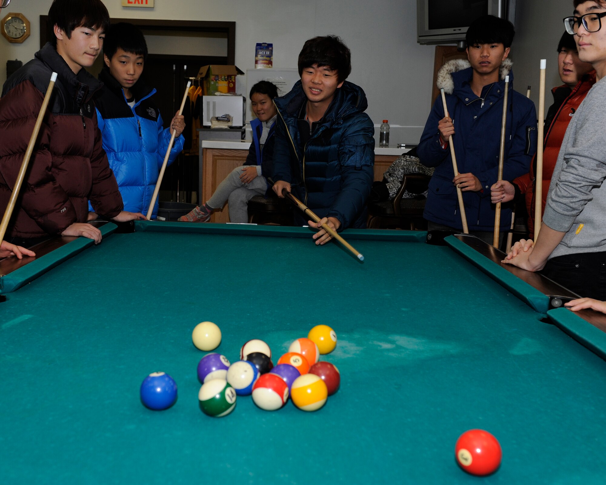 Children from Illmagwon Orphanage play a game of billiards at the Ace in the Hole on Kunsan Air Base, Republic of Korea, Dec, 1, 2012, during a Christmas party. This was the first time the Team 5/6 NCO club sponsored the orphanage Christmas party. (U.S. Air Force photo by Senior Airman Marcus Morris/released)