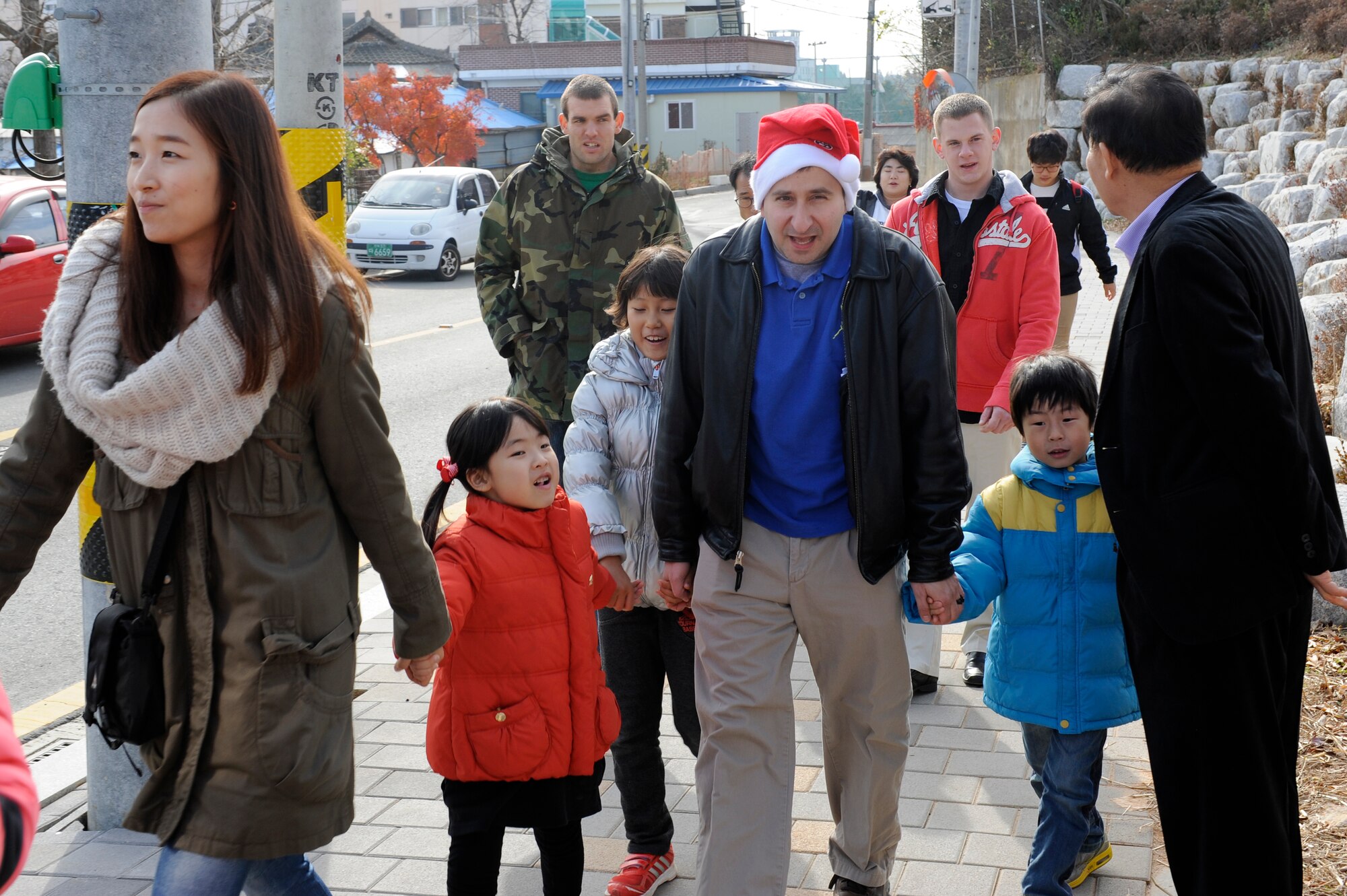 Volunteers from Kunsan Air Base, Republic of Korea gather children from Ilmagwon Orphanage to celebrate Christmas with them on base, Dec, 1, 2012,. The annual tradition allows volunteers to give gifts to local children they spend time with. (U.S. Air Force photo by Senior Airman Marcus Morris/released)
