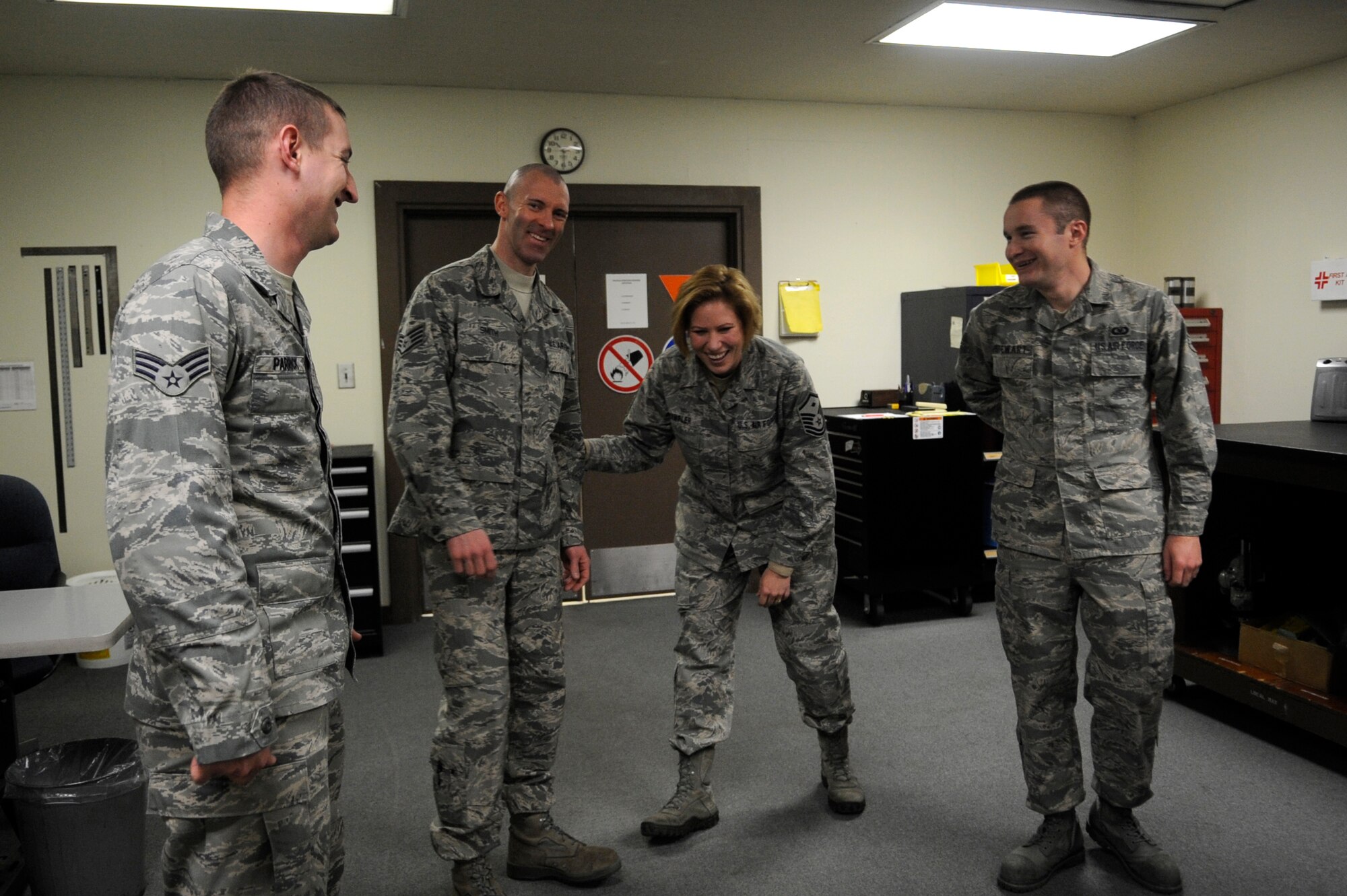 Master Sgt. Jennifer Wampler, outgoing 8th Operations Group first sergeant, shares a last laugh with Airmen from the 8th Operations Support Squadron aircrew flight equipment shop Dec. 11, 2012, at Kunsan Air Base, Republic of Korea. During her year with the 8th OG, Wampler made a point to learn as much as possible about her Airmen and their jobs. (U.S. Air Force photo by Senior Airman Brigitte N. Brantley/Released)
