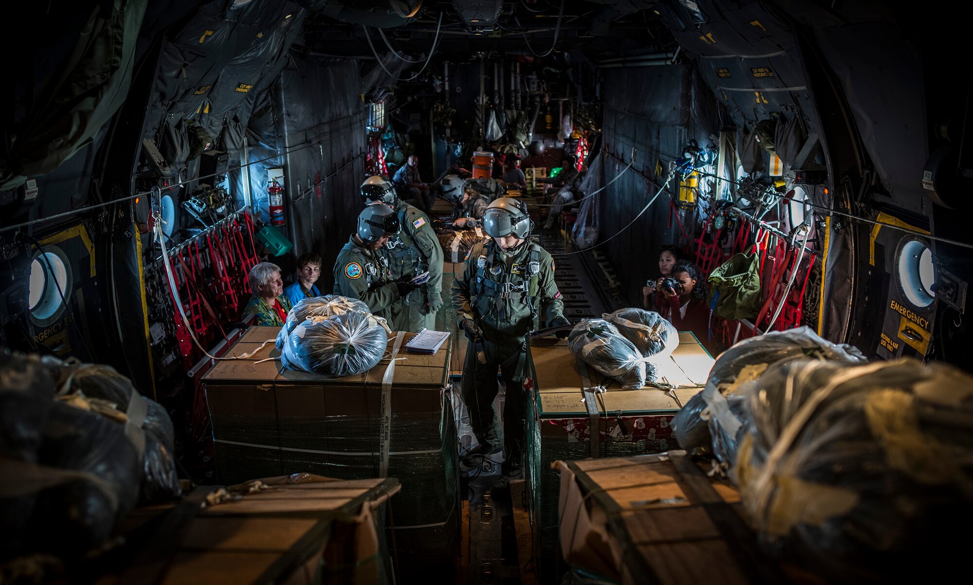 Loadmasters from the 36th Airlift Squadron, Yokota Air Base, Japan, prepare humanitarian aid bundles destined for remote islands within the Micronesian Island Dec. 11, 2012, during the 61st anniversary of Operation Christmas Drop. Operation Christmas Drop is a non-profit organization powered by volunteers from Andersen Air Force Base and the local Guam community. Each year OCD provides aid to over 30,000 islanders in Chuuk, Palau, Yap, Marshall Islands and Commonwealth of the Northern Mariana Islands. This year is the 61st anniversary of OCD, making it the longest running humanitarian mission in the world. (U.S. Air Force photo by Tech. Sgt. Samuel Morse/Released)