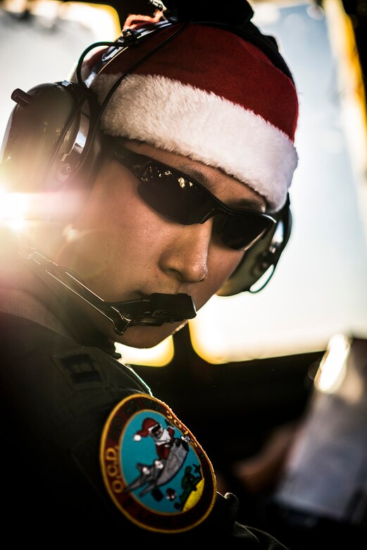 Capt. Matthew Yan, 36th Airlift Squadron pilot and aircraft commander, turns to his copilot after takeoff from Yokota Air Base, Japan, Dec. 10, 2012. Yan and his crew flew to Andersen Air Force Base, Guam, to participate in the annual Operation Christmas Drop, flying supplies to the Micronesian Islands. (U.S. Air Force photo by Tech. Sgt. Samuel Morse)