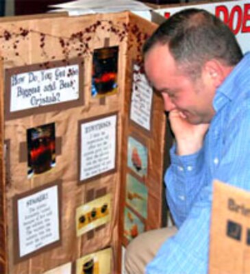 ERDC-GSL's Josh McCleave studies the Warren Central Intermediate School project he, along with his fellow judges, selected as "Best in Show" among the 181 entries in the annual fair. 