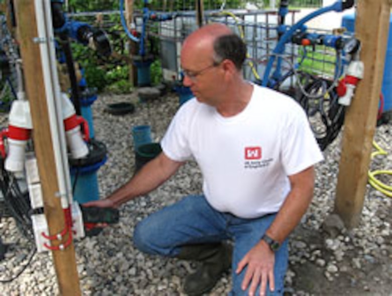 ERDC Engineer Dr. David Gent checks the electric current applied to one of the electrodes in an electrode well during his two-month demonstration project in Denmark.