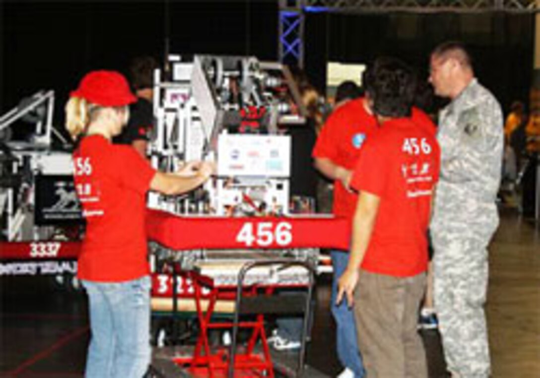 Robotics Team 456 members prepare their machine with encouragement from ERDC Commander Col. Kevin Wilson, right, at the recent basketball toss games in New Orleans.