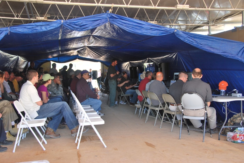 Event attendees watch as up and coming computer based software is demonstrated amid simulated fire and sniper attacks during the recent  Deployable Force Protection demonstration at Fort Polk, La. 