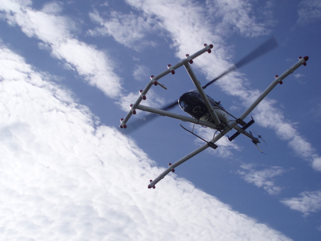 The helicopter magnetometer detects magnetic anomalies on the ground or in shallow surfaces. The device flies six feet above ground at speeds of 30 to 40 mph. 