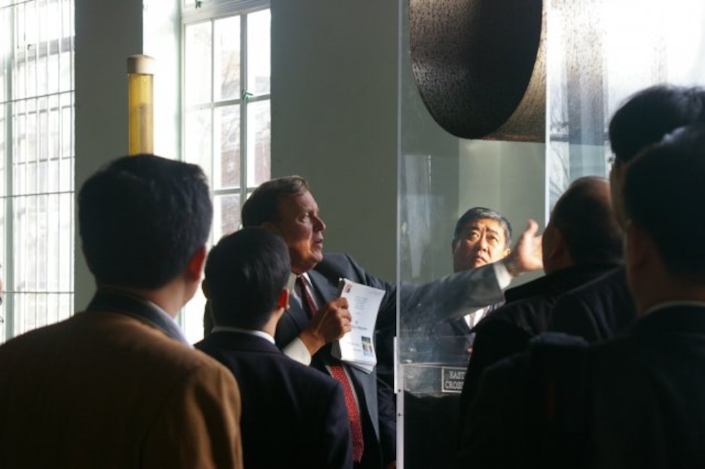Tom Jacobus, Washington Aqueduct general manager, demonstrates the properties of a dual media filter (on a scale model) prior to the group seeing the operational, large-scale filters in action.
