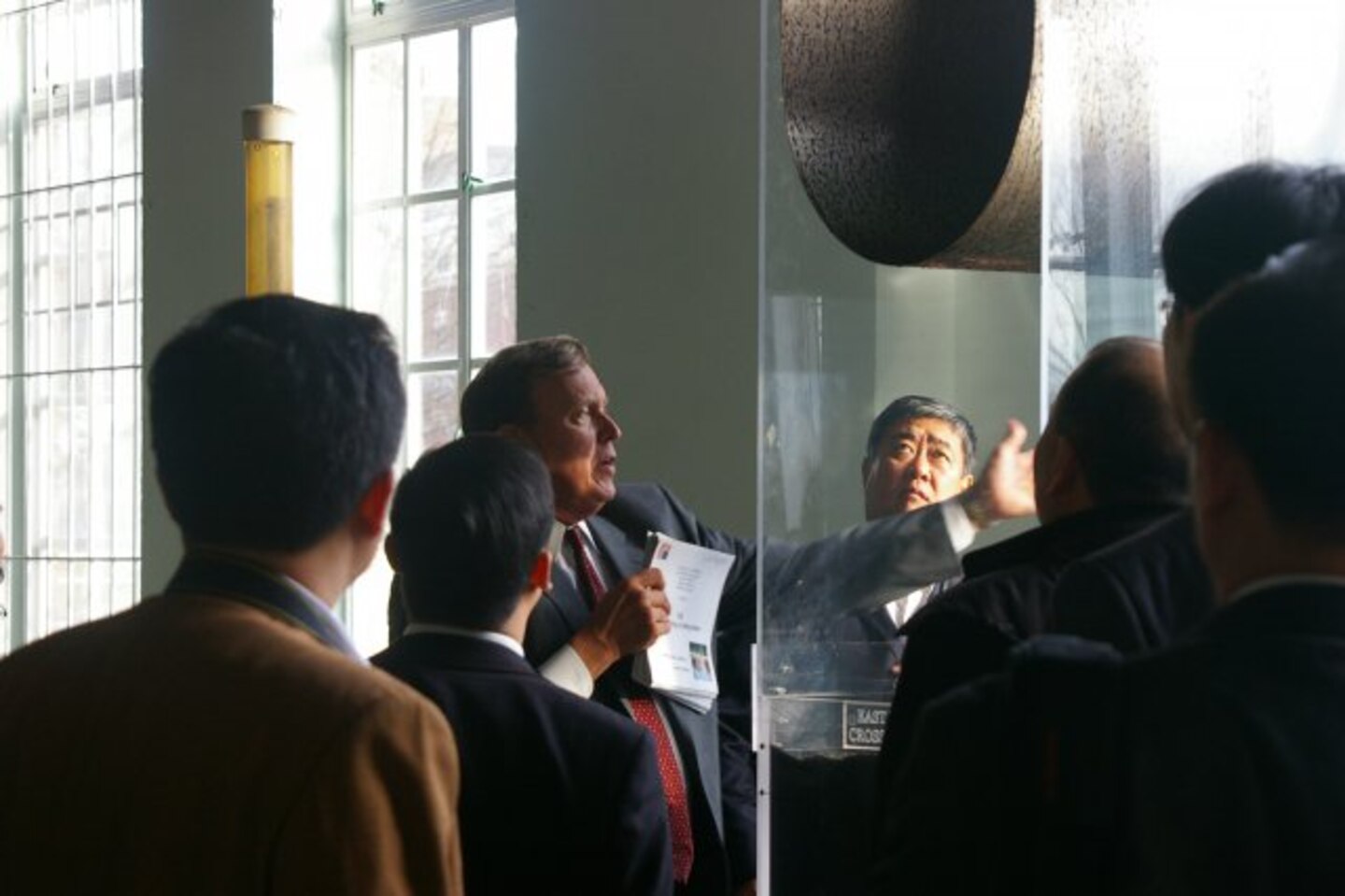 Tom Jacobus, Washington Aqueduct general manager, demonstrates the properties of a dual media filter (on a scale model) prior to the group seeing the operational, large-scale filters in action.
