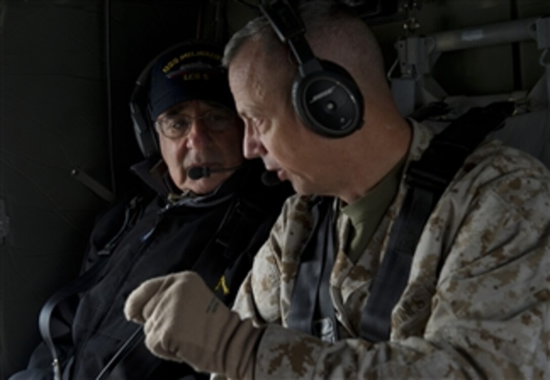 Secretary of Defense Leon E. Panetta, left, listens to Commander, International Security Force, Afghanistan Gen. John Allen as they fly over Kabul, Afghanistan, on Dec. 12, 2012.  Panetta is on a five-day trip to the region to meet with the troops and senior leadership.  