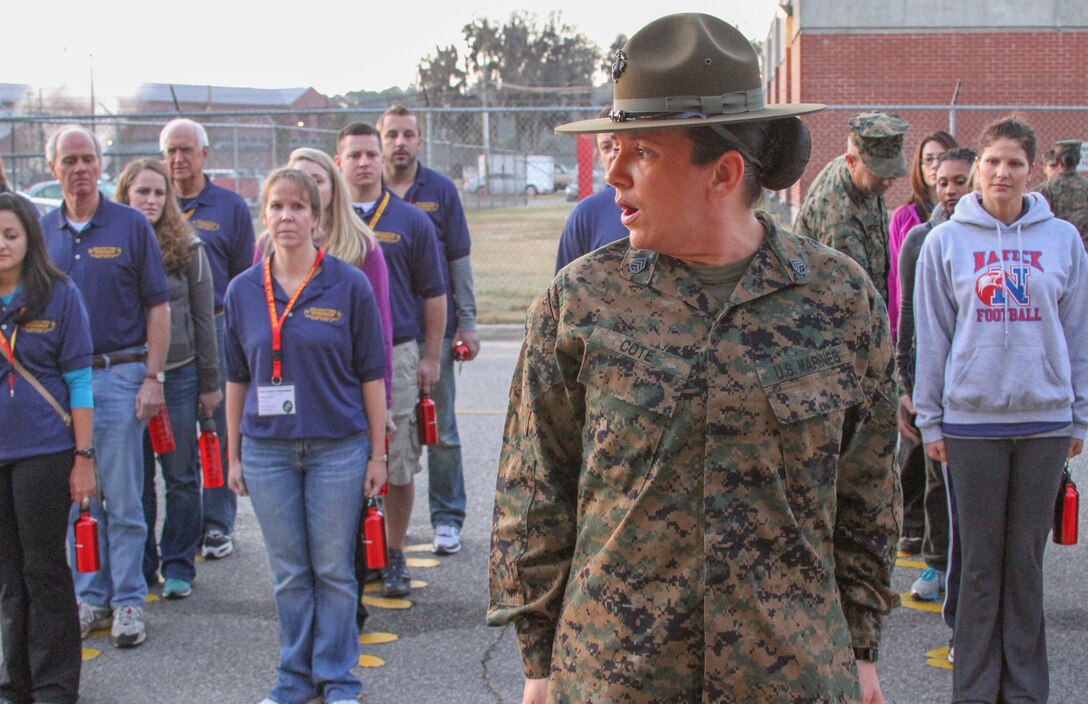 Staff Sgt. Jessica J. Cote, a drill instructor at Marine Corps Recruit Depot Parris Island, S.C., originally from Detroit, teaches basic drill to educators from the Harrisburg, Pa., and Portsmouth, N.H., areas during the first day of the Educator Workshop at MCRD Parris Island, Dec. 5.  The workshop brings together teachers, administrators and other education professionals aboard the depot and gives them the opportunity to experience what recruit training is like in the Corps.  (U.S. Marine Corps photo by Sgt. Bryan Lett)