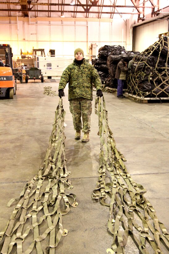 TRONDHEIM, Norway - Master Sergeant Steven Albanese, facilities chief, Marine Forces, Europe drags two cargo nets to a cluster of pallets, while assembling a shipment of sustainment equipment headed to the Republic of Georgia to support the Georgia Deployment Program. During the course of three days a team of five Marines from Marine Forces, Europe, II Marine Expeditionary Force and two airmen from the 819th Red Horse Squadron  assembled 14 pallets of gear, set to be delivered to training areas in the Republic of Georgia.  The shipment contained tents, a shower system, tool kits, generators, fuel bladders and host of other items, intended to help the Marines and their Georgian counterparts, to enhance the living conditions in training areas in the Republic of Georgia. 