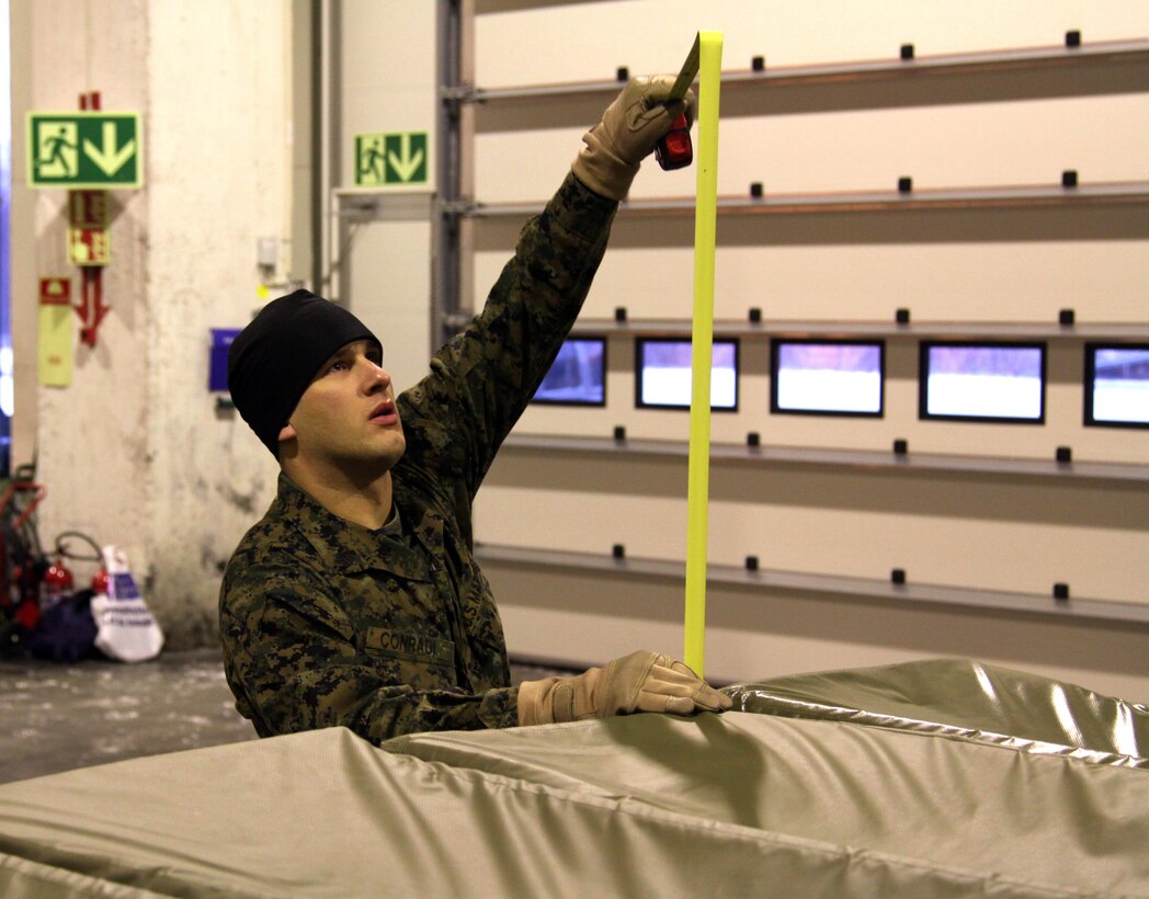 TRONDHEIM, Norway - Staff Sergeant Joseph Conradi, embark specialist, Marine Forces, Europe measures the height of equipment on a pallet, while assembling a shipment of sustainment equipment headed to the Republic of Georgia to support the Georgia Deployment Program. During the course of three days a team of five Marines from Marine Forces, Europe, II Marine Expeditionary Force and two airmen from the 819th Red Horse Squadron  assembled 14 pallets of gear, set to be delivered to training areas in the Republic of Georgia.  The shipment contained tents, a shower system, tool kits, generators, fuel bladders and host of other items, intended to help the Marines and their Georgian counterparts, to enhance the living conditions in training areas in the Republic of Georgia. 