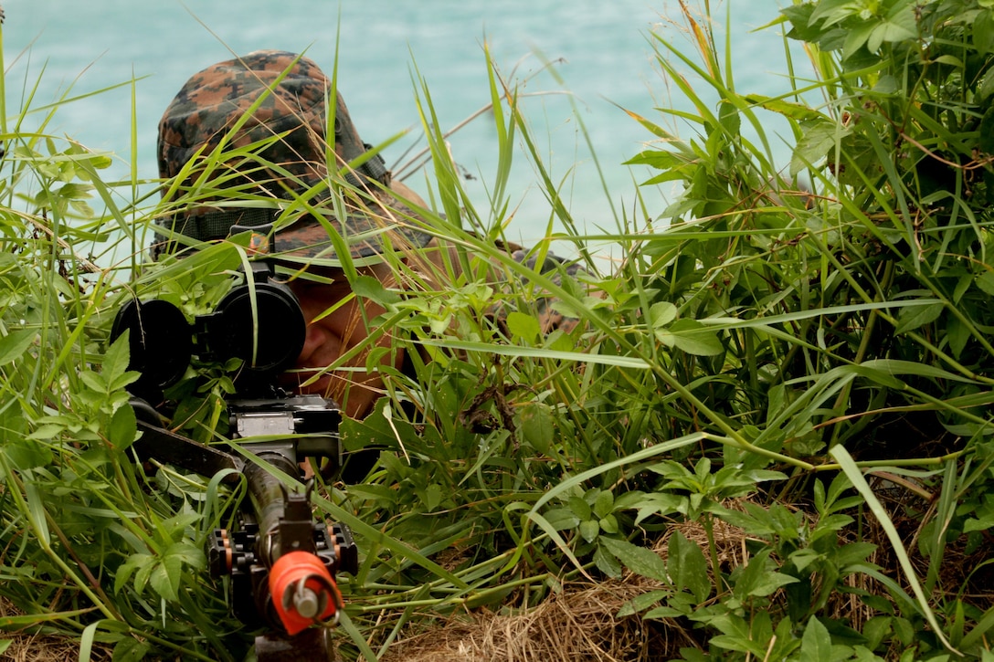 Lance Cpl. Nicholas D. Alen, a machine gunner with Company E., Battalion Landing Team 2nd Battalion, 1st Marine regiment, 31st Marine Expeditionary Unit, provides security while the rest of the raid force takes accountability during boat raid training here, July 11. The raid was part of a pre-deployment training package. The 31st MEU is the United States force in readiness for the Asia Pacific region.