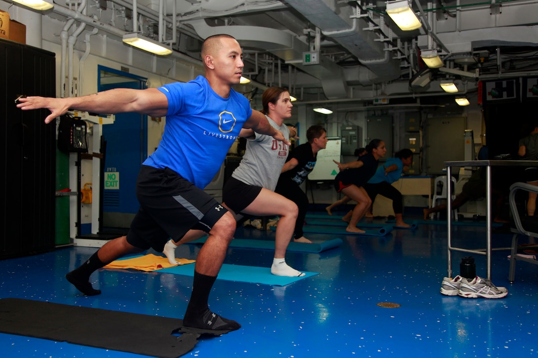 First Lt. Dale D. Dumo, officer-in-charge, Marine Aviaition Logistics Squadron Detachment, 15th Marine Expeditionary Unit, performs movements during a PITAIYO class in the medical facility aboard the USS Peleliu, Dec. 7 PITAIYO, an acronym for put it together all in your orbit, is a fusion of Pilates, Tai-chi, and yoga blended into one class. It is designed to increase core strength, flexibility, balance and coordination. The class is another opportunity Marines and sailors have to allow their minds to decompress from the stresses of deployment. The 15th MEU is deployed as part of the Peleliu Amphibious Ready Group as a U.S. Central Command theater reserve force, providing support for maritime security operations and theater security cooperation efforts in the U.S. 5th Fleet area of responsibility. Dumo, 31, is from Houston. (U.S. Marine Corps photo by Cpl. John Robbart III)
