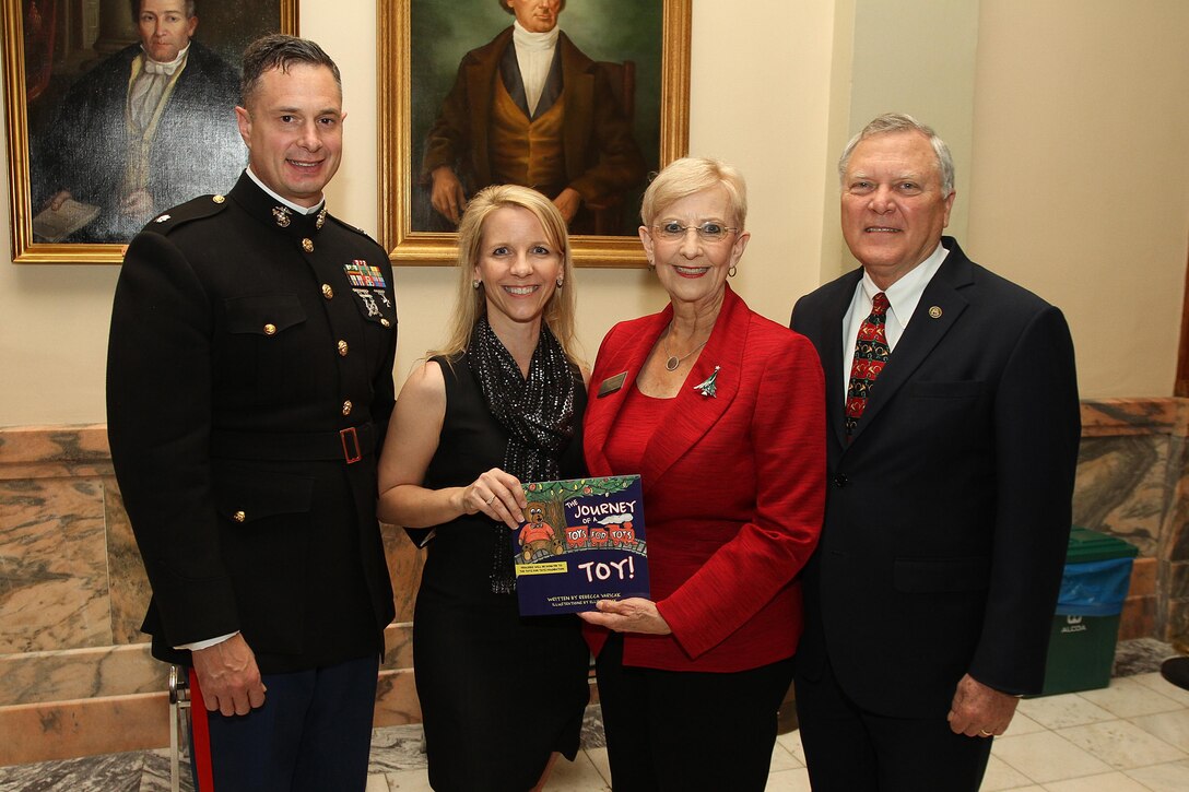 (From left to right) Lt. Col. Michael Varicak, Rebecca Varicak, Sandra Deal, and Nathan Deal celebrate the lighting of the Christmas tree and the release of the Varicak's book, "The Journey of a Toys for Tots Toy!" at the capitol in Atlanta, Dec. 5. The book illustrates the process a toy goes through when it has been donated to the Marine Corps Reserve's Toys for Tots program. All proceeds from the sale of the book will be donated to the Toys for Tots Foundation.