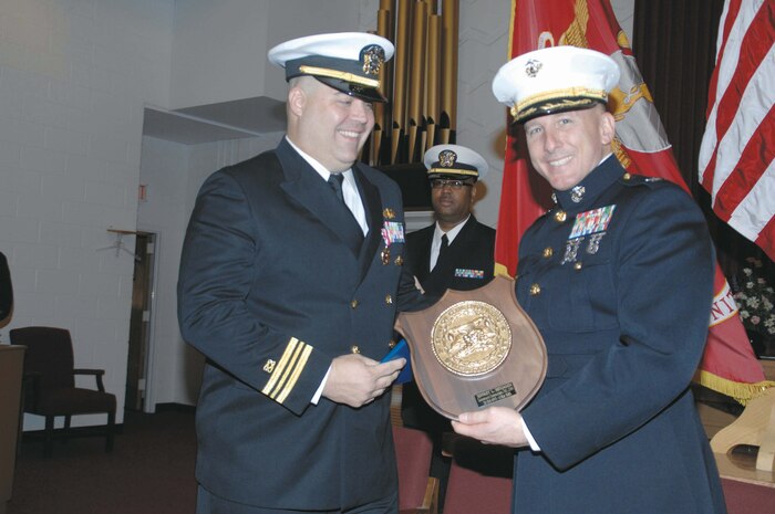 Lt. Cmdr. Jeffrey L. Benjamin, public works officer and resident officer-in-charge of construction, Installation and Environmental Division, Marine Corps Logistics Base Albany, is presented numerous awards and letters of recognition during his retirement ceremony, Friday.  The retirement ceremony was held in the Base Chapel. 