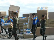 Philippine service members and U.S. Marines palletize relief supplies Dec. 13 at Villamor Air Base in Manila during humanitarian assistance and disaster relief operations. After palletizing the gear side by side, the Marines transported the supplies via KC-130J Hercules aircraft to Davao International Airport for further distribution to citizens in need throughout Mindanao, the region of the Philippines most affected by Typhoon Bopha, which made landfall Dec. 4. The U.S. Marines are landing support specialists with 3rd Marine Logistics Group, III Marine Expeditionary Force, and embarkation specialists with 3rd MLG and 1st Marine Aircraft Wing, III MEF. The aircraft that transported the supplies are with Marine Aerial Refueler Squadron 152, Marine Aircraft Group 36, 1st MAW. 
