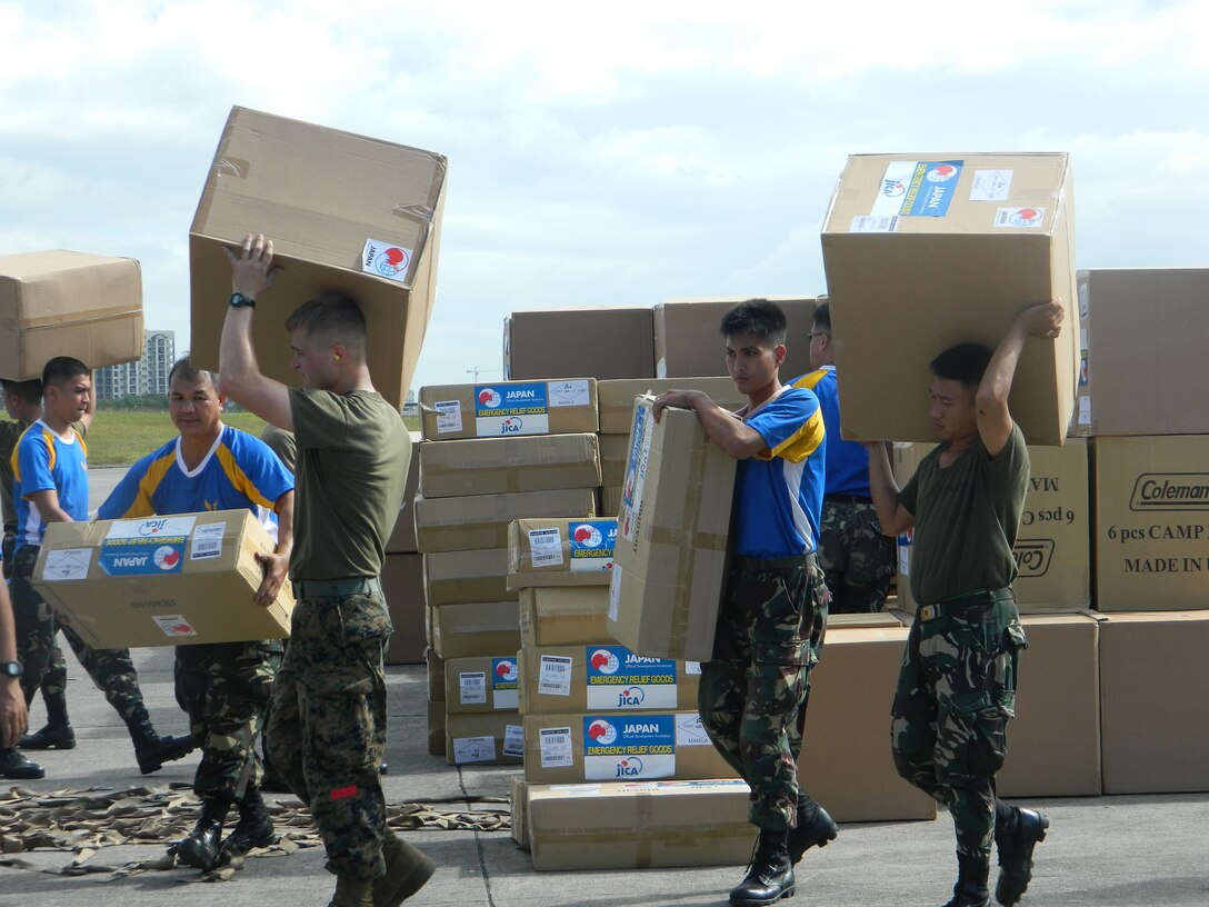 Philippine service members and U.S. Marines palletize relief supplies Dec. 13 at Villamor Air Base in Manila during humanitarian assistance and disaster relief operations. After palletizing the gear side by side, the Marines transported the supplies via KC-130J Hercules aircraft to Davao International Airport for further distribution to citizens in need throughout Mindanao, the region of the Philippines most affected by Typhoon Bopha, which made landfall Dec. 4. The U.S. Marines are landing support specialists with 3rd Marine Logistics Group, III Marine Expeditionary Force, and embarkation specialists with 3rd MLG and 1st Marine Aircraft Wing, III MEF. The aircraft that transported the supplies are with Marine Aerial Refueler Squadron 152, Marine Aircraft Group 36, 1st MAW. 
