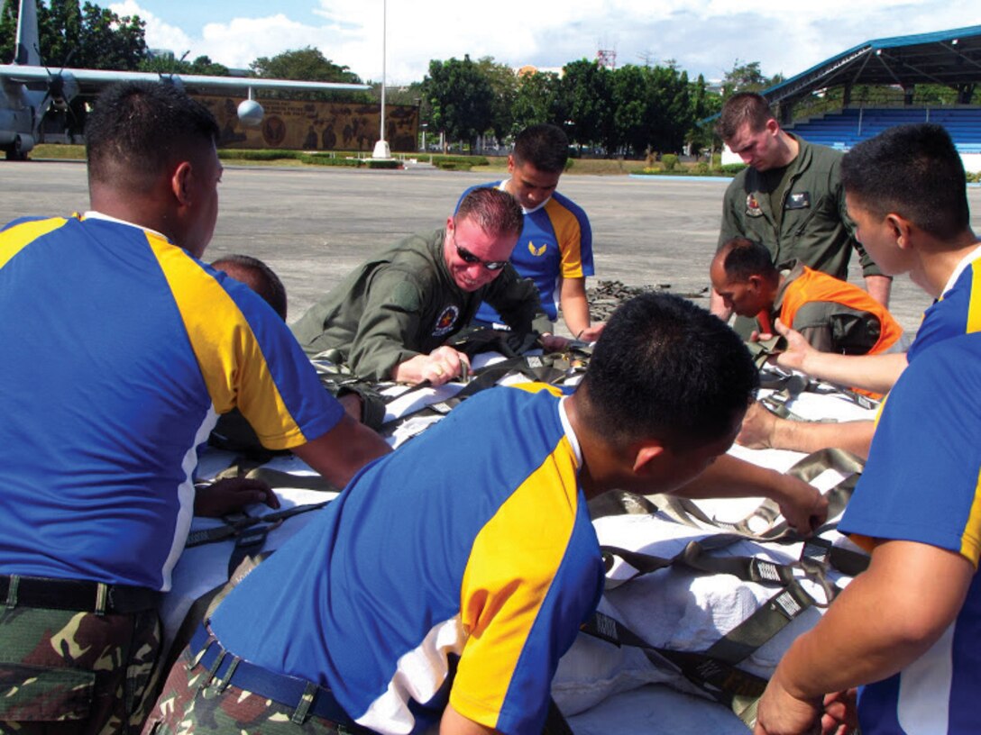 Philippine Air Force members and U.S. Marines load family ration packs Dec. 11 at Villamor Air Base in Manila during humanitarian assistance and disaster relief operations. The Marines transported the supplies via KC-130J Hercules aircraft to Davao International Airport for further distribution to citizens in need throughout Mindanao, the region of the Philippines most affected by Typhoon Bopha, which made landfall Dec. 4. The U.S. Marines are with Marine Aerial Refueler Transport Squadron 152, Marine Aircraft Group 36, 1st Marine Aircraft Wing, III Marine Expeditionary Force. 