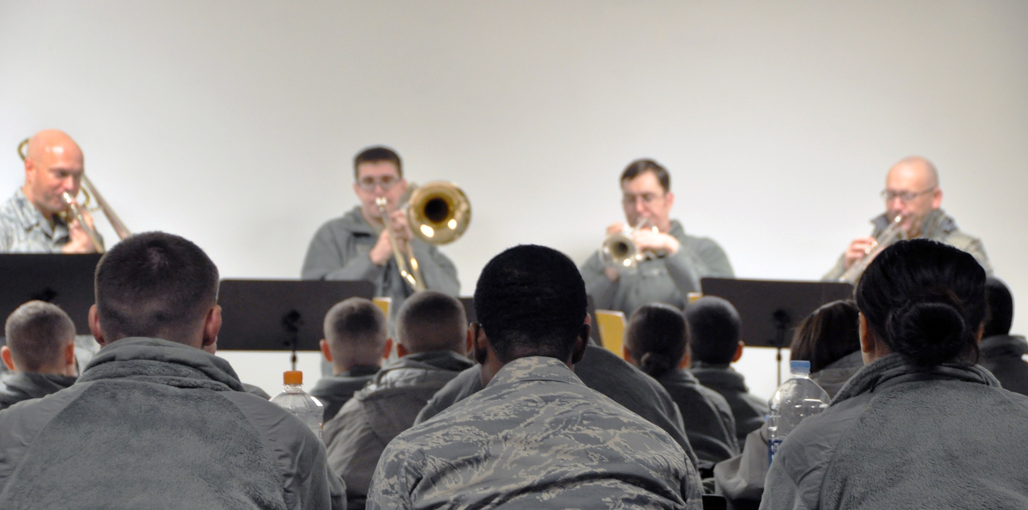 Members of the 51st Security Forces Squadron took a break from training to hear the United States Air Force Band of the Pacific-Asia play holiday tunes at Bldg. 1237, Dec. 13, 2012. The Pacific Brass stopped at several squadrons on base to boost morale and spread holiday cheer to Team Osan. (U.S. Air Force photo/Senior Airman Kristina Overton)