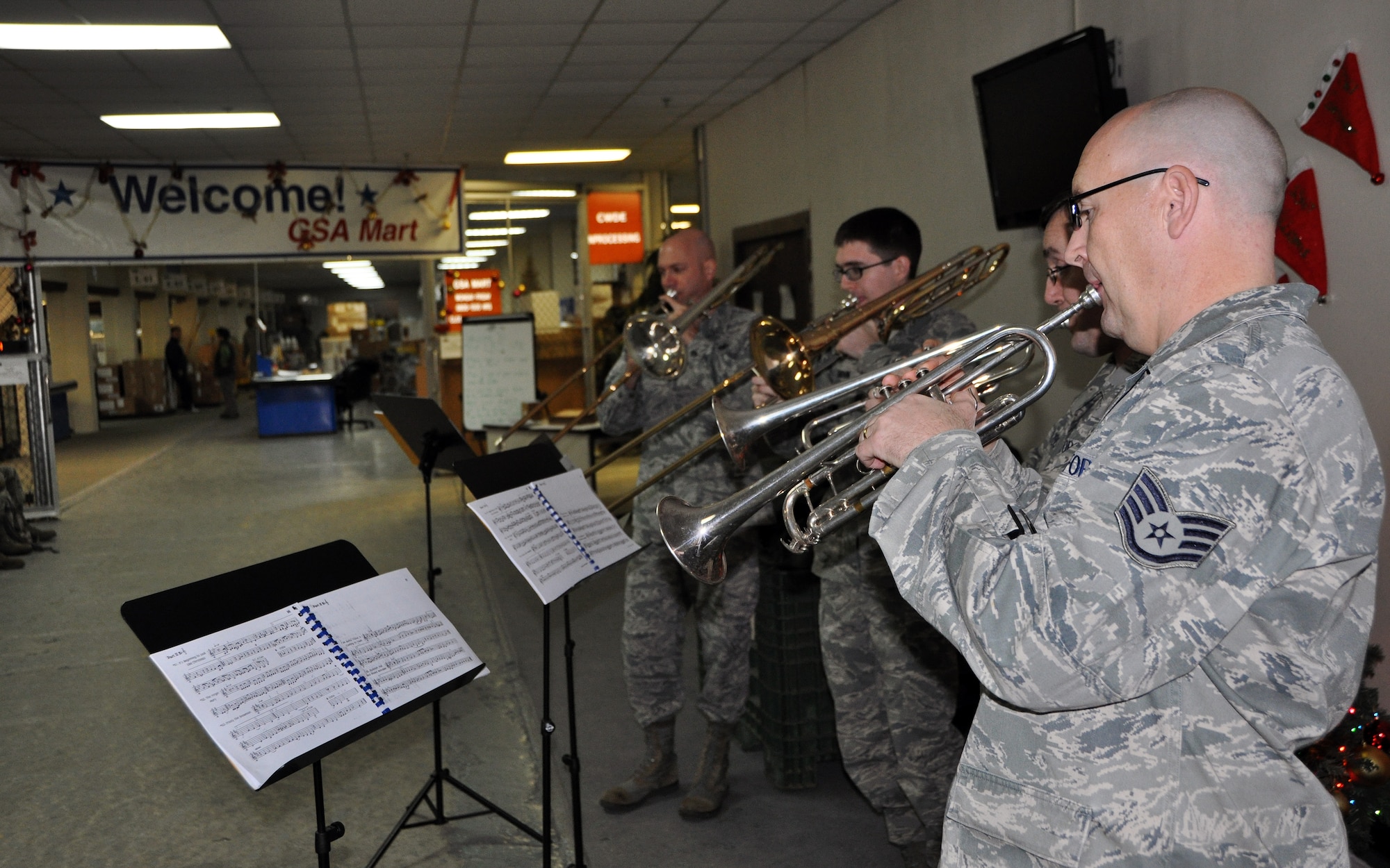 The United States Air Force Band of the Pacific-Asia’s brass quartet stopped in at the 51st Logistics Readiness Squadron, Dec. 12, 2012, to play some Christmas favorites. The Band of the Pacific-Asia consists of full time active duty musicians performing throughout an area of responsibility which spans the Pacific Ocean from the Arctic Circle to Australia, and from the Polynesian Islands to the east coast of India, to include all of Southeast Asia. (U.S. Air Force photo/Senior Airman Kristina Overton)