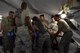 ANDERSEN AIR FORCE BASE, Guam--Airmen work together to treat a simulated injured patient during the Expeditionary Medical Support Health Response Team training on Andersen Air Force Base, Guam, Dec. 12, 2012. The exercise focused on mass-casualty training scenarios and humanitarian aid in response to crisis situations. During the weeklong exercise, medical Airmen from Joint Base Elmendorf-Richardson, Alaska, Yokota Air Base, Japan and Andersen worked together in setting up and training in the EMEDS HRT tents.( U.S. Air Force Photo by Staff Sgt. Alexandre Montes/Released)