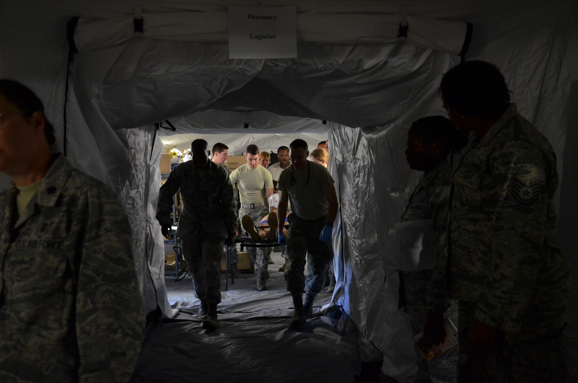 ANDERSEN AIR FORCE BASE, Guam--Airmen transport a simulated victim on a gurney during the Expeditionary Medical Support Health Response Team training on Andersen Air Force Base, Guam, Dec. 12, 2012. The exercise focused on mass-casualty training scenarios and humanitarian aid in response to crisis situations. During the weeklong exercise, medical Airmen from Joint Base Elmendorf-Richardson, Alaska, Yokota Air Base, Japan and Andersen worked together in setting up and training in the EMEDS HRT tents.( U.S. Air Force Photo by Staff Sgt. Alexandre Montes/Released)