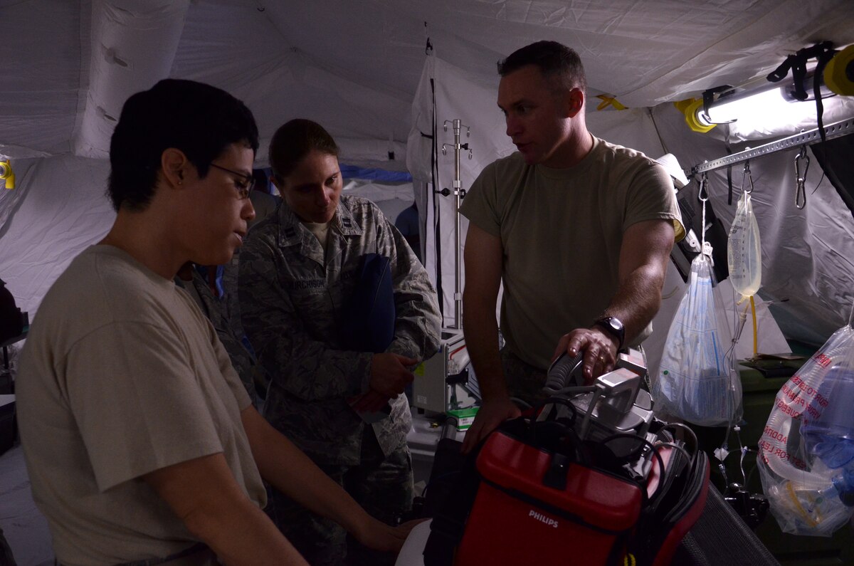 ANDERSEN AIR FORCE BASE, Guam--Master Sgt. Jason Bradley, 374th Medical Operations Squadron, instructs his team on using a defibrillator prior to the Expeditionary Medical Support Health Response Team training on Andersen Air Force Base, Guam, Dec. 12, 2012. The exercise focused on mass-casualty training scenarios and humanitarian aid in response to crisis situations. During the weeklong exercise, medical Airmen from Joint Base Elmendorf-Richardson, Alaska, Yokota Air Base, Japan and Andersen worked together in setting up and training in the EMEDS HRT tents.( U.S. Air Force Photo by Staff Sgt. Alexandre Montes/Released)