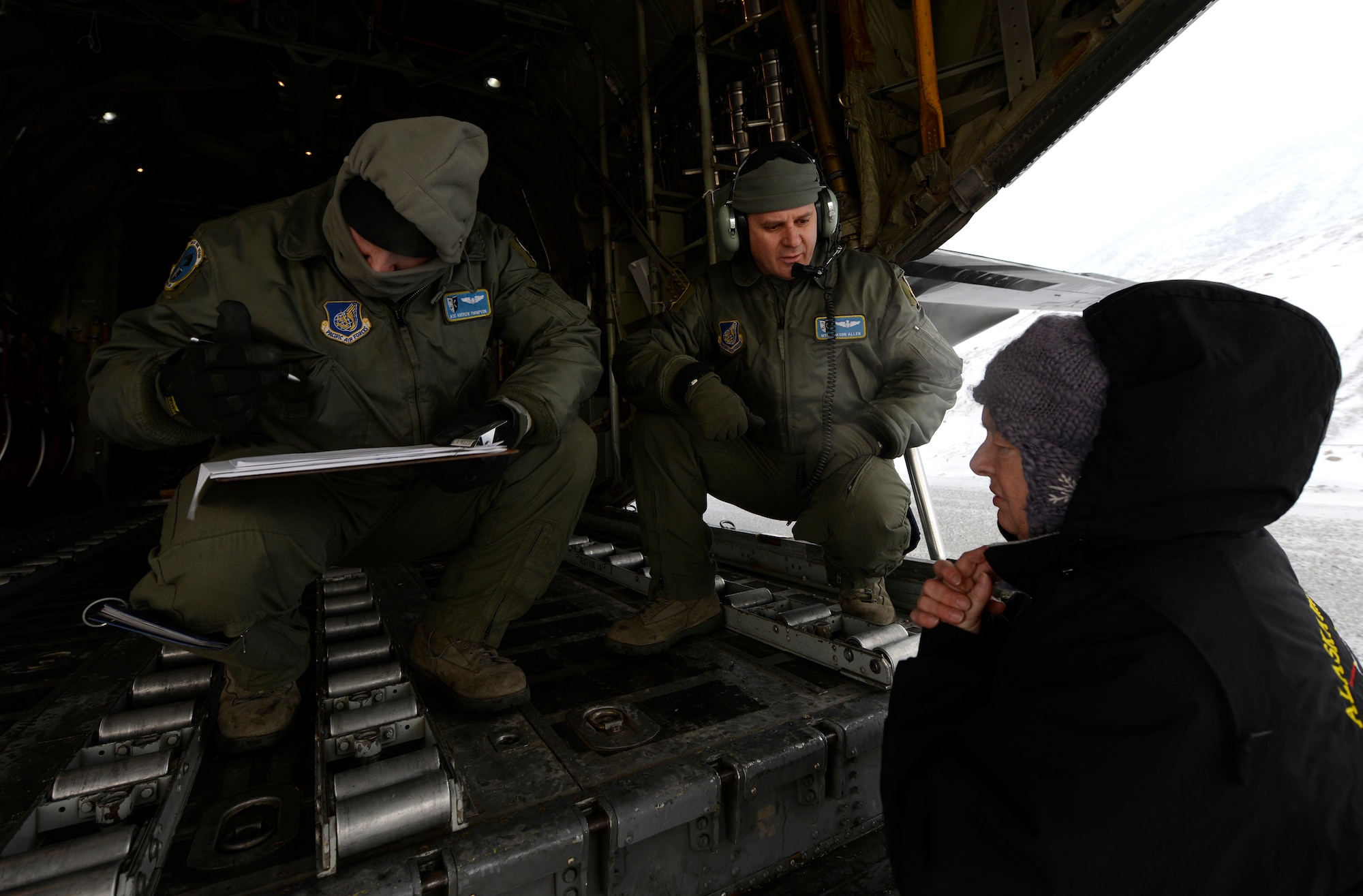 Master Sgt. Jason Allen, right, and Airman 1st Class Andrew Thompson fill out paperwork after delivering three supply pallets to Cape Romanzof, Alaska, Dec. 4. Cape Romanzof is a radar site which is part of the North Warning System, a 2,983-mile long and 199-mile wide "tripwire" stretching from Alaska, through Canada, to Southern Labrador. The radar sites cannot operate without these resupply missions, as many of the sites have no roads in or out. Allen and Thompson are C-130 Hercules loadmasters assigned to the 537th Airlift Squadron. (U.S. Air Force photo/Tech Sgt. Brian Ferguson)