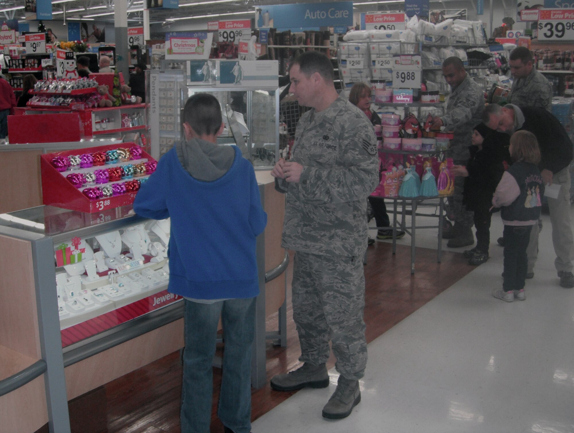 Personnel from Mountain Home Air Force Base, Idaho, assist local children in holiday shopping Dec. 1, 2012, at the local Wal-Mart. The 16th annual Shop with a Cop event is designed to help promote a positive civilian and military police force image in the local community. (Courtesy photo)