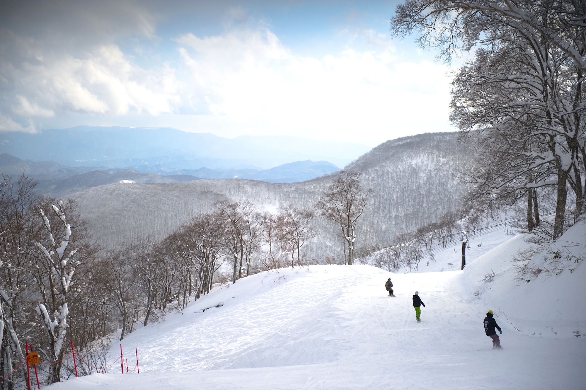 HAKUBA, Japan – Three Yokota snowboarders slide down the red slope at Hakuba Ski and Snowboard Resort on Dec. 12, 2012. Japan categorizes slopes by green, red and black. Green for beginner, red for intermediate and black for expert only.  (U.S. Air Force photo by Staff Sgt. Chad C. Strohmeyer)
