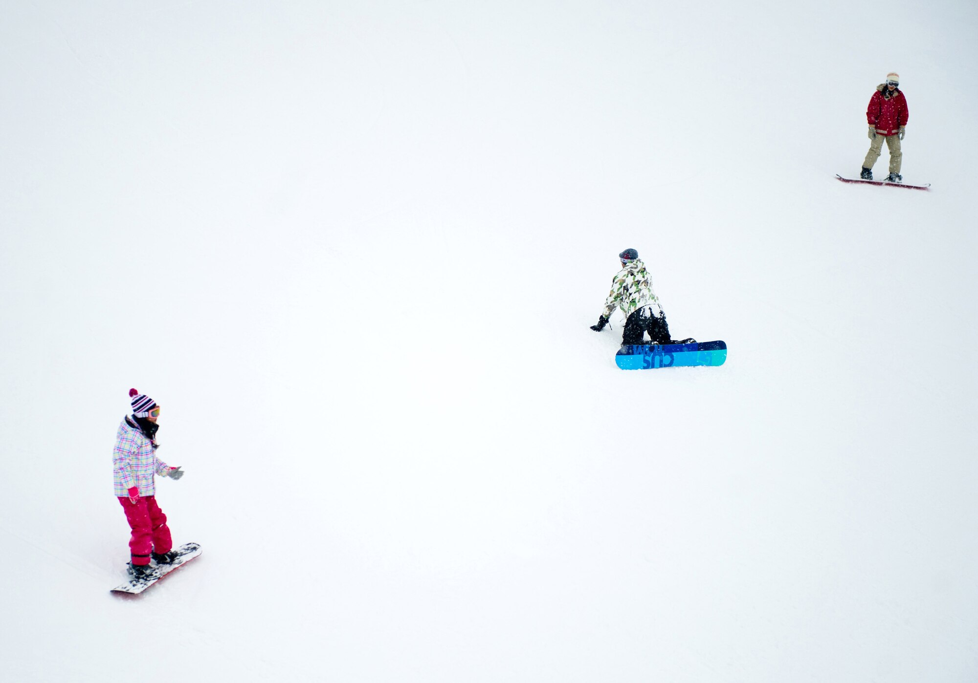 HAKUBA, Japan – Three Yokota snowboarders slide down the green slope at Hakuba Ski and Snowboard Resort on Dec. 12, 2012. By signing up with Outdoor Recreation, Yokota skiers and snowboarders have access to dozens of resorts all over Japan. (U.S. Air Force photo by Staff Sgt. Chad C. Strohmeyer)