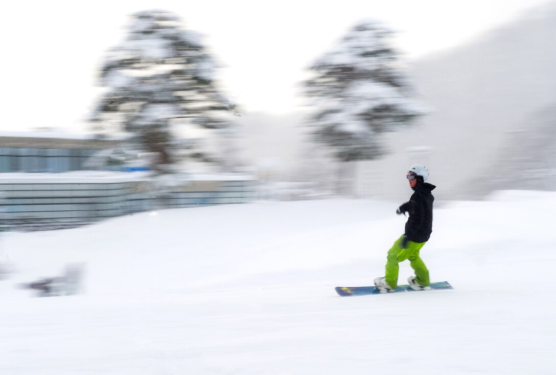 HAKUBA, Japan – A Japanese snowboarder slides to a stop after completing the green slope at Hakuba Ski and Snowboard Resort on Dec. 12, 2012. With only approximately 100 skiers and snowboarders on the mountain, Yokota winter enthusiasts were able to enjoy clutter-free slopes.  (U.S. Air Force photo by Staff Sgt. Chad C. Strohmeyer)