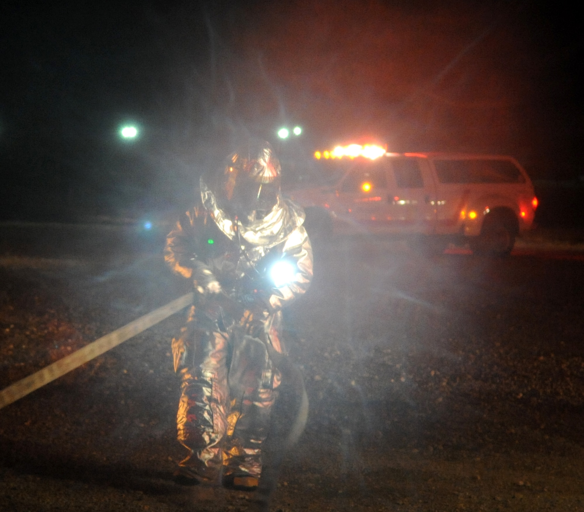 A fire fighter from the 633rd Civil Engineering Squadron pulls out a hose during a phase I combined unit exercise at Langley Air Force Base, Va., Dec. 12, 2012. The CUE provided hands-on training to first responders. (U.S. Air Force photo by Senior Airman Racheal E. Watson/Released)