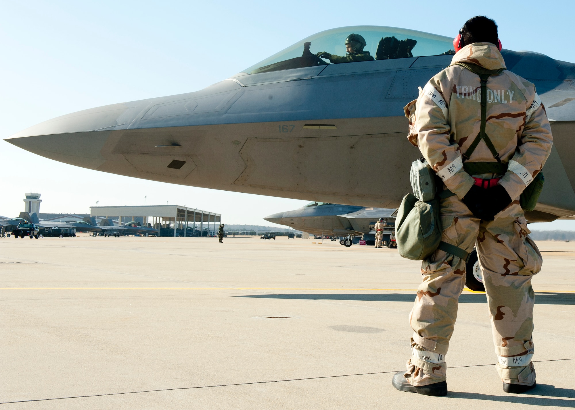 Airman 1st Class Aldrin Magbag, 192nd Aircraft Maintenance Squadron, prepares to taxi an F-22A during the phase II combined unit exercise at Langley Air Force Base, Va., Dec. 13, 2012.   The CUE was held to help Langley Airmen prepare for future deployments. (U.S. Air Force photo by Staff Sgt. John D. Strong II/Released) 