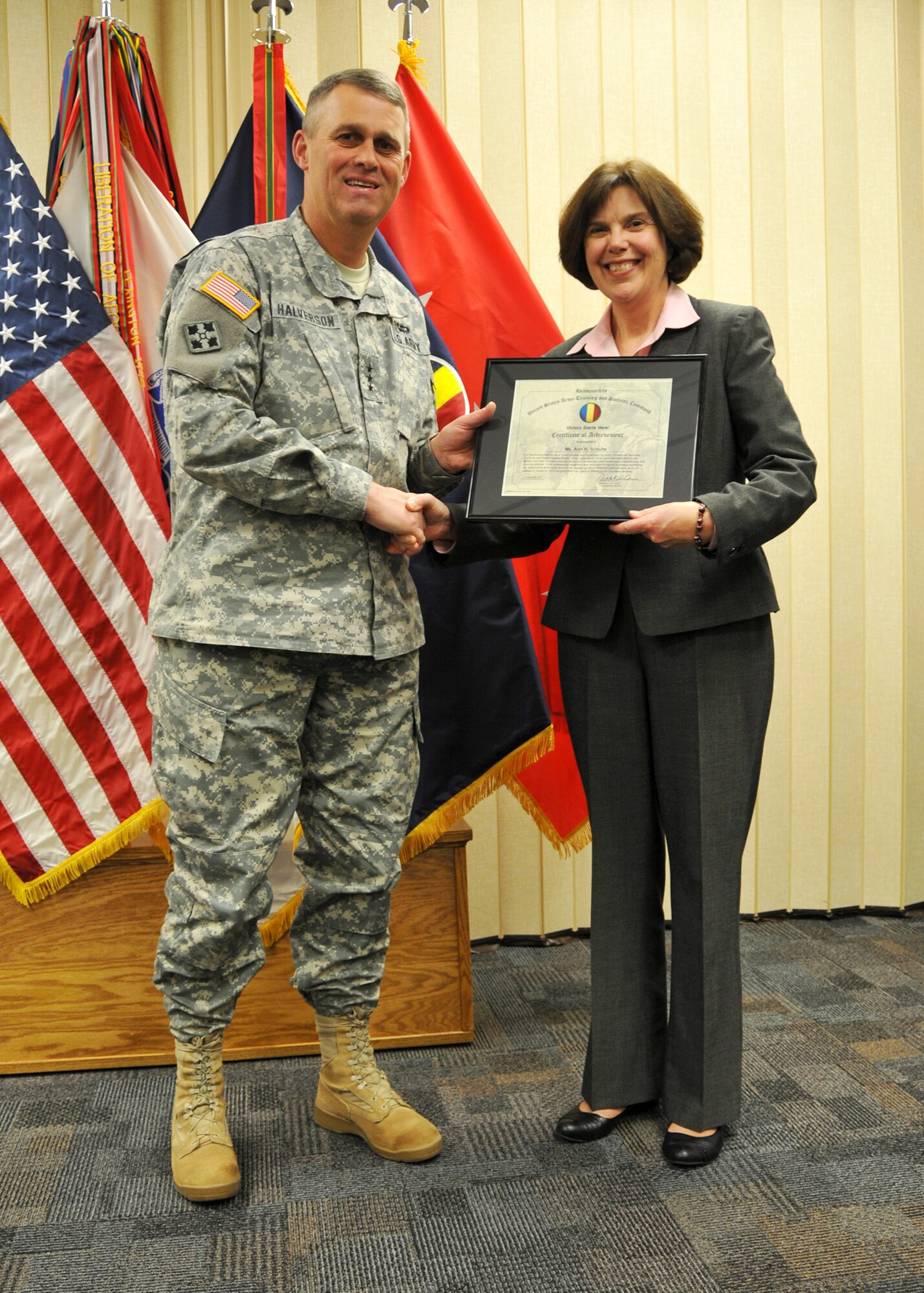 FORT EUSTIS, Va. – U.S. Army Lt. Gen. David Halverson, deputy commanding general of U.S. Army Training and Doctrine Command, recognizes Ann Schulte, departing director of Army Community Service, for her commitment to Joint Base Langley-Eustis Service members and their families, Dec. 12, 2012, at the Soldier Support Center on Fort Eustis, Va. Schulte’s new position will be program analyst at the Office of the Deputy Assistant Secretary of Defense for Military Community and Family Policy, in Alexandria, Va. (U.S. Army photo by Sgt. 1st Class Kelly Jo Bridgwater/Released)