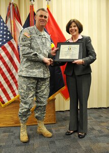 FORT EUSTIS, Va. – U.S. Army Lt. Gen. David Halverson, deputy commanding general of U.S. Army Training and Doctrine Command, recognizes Ann Schulte, departing director of Army Community Service, for her commitment to Joint Base Langley-Eustis Service members and their families, Dec. 12, 2012, at the Soldier Support Center on Fort Eustis, Va. Schulte’s new position will be program analyst at the Office of the Deputy Assistant Secretary of Defense for Military Community and Family Policy, in Alexandria, Va. (U.S. Army photo by Sgt. 1st Class Kelly Jo Bridgwater/Released)