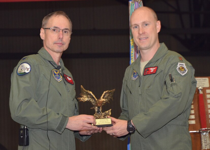 Col Greg Champagne, 131st Bomb Wing commander, presents the 131st Bomb Wing  Pilot of the Year eagle award to Maj. Geoffrey "Zorro"  Billingsley, during the annual Wing All Call, Dec 9, at Whiteman AFB.   Billingsley was recognized among his peers for outstanding achievements for the Wing throughout 2012. (National Guard Photo by Staff Sgt.Sean Navarro)