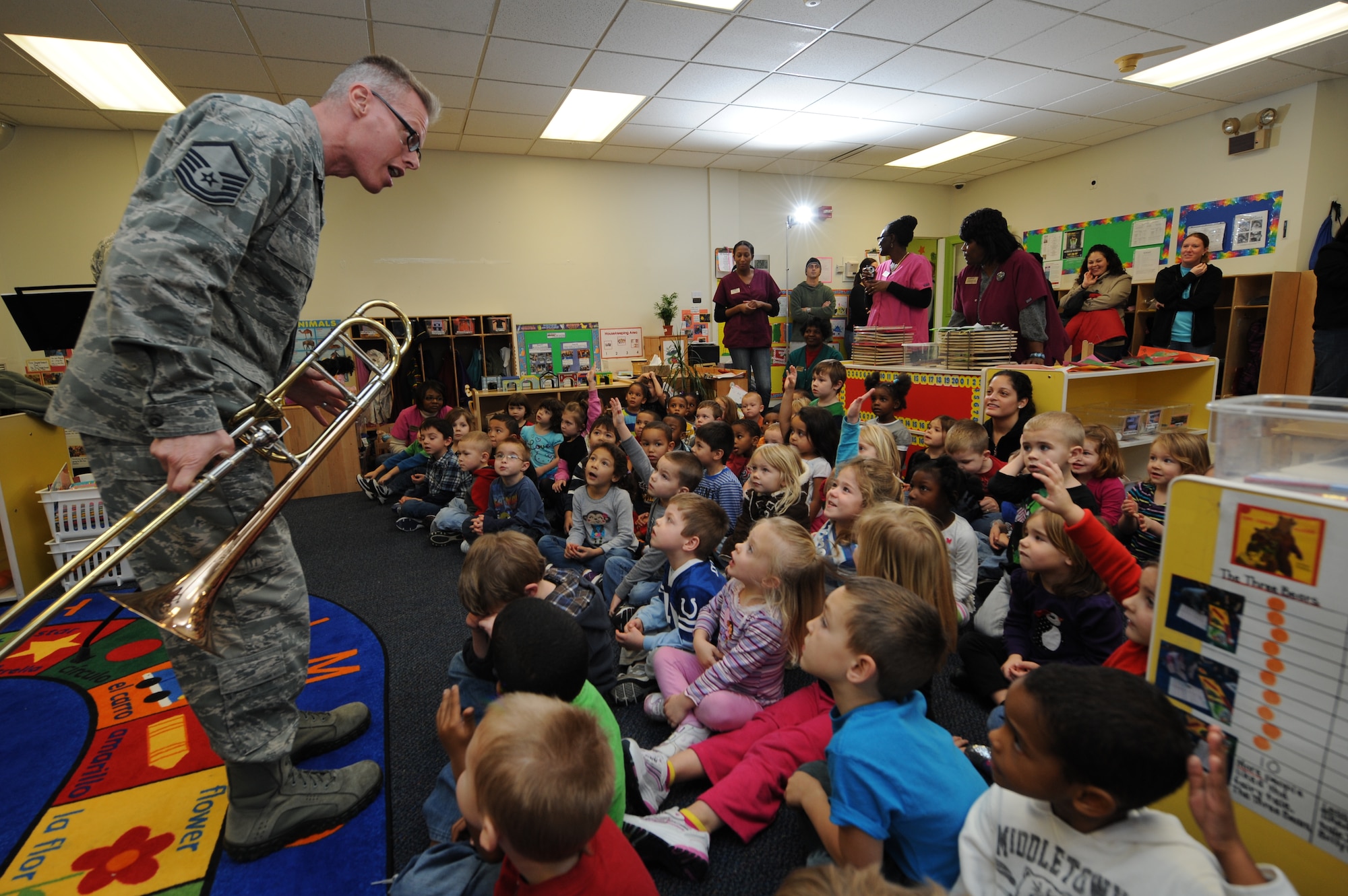 U.S. Air Force Master Sgt. John Cisar, USAF Heritage of America Band trombonist, takes requests from children at the child development center on Seymour Johnson Air Force Base, N.C., Dec. 12, 2012. The band’s brass quartet played holiday tunes including Frosty the Snowman and We Wish You a Merry Christmas for children and their parents. (U.S. Air Force photo/Airman 1st Class Aubrey White/Released)