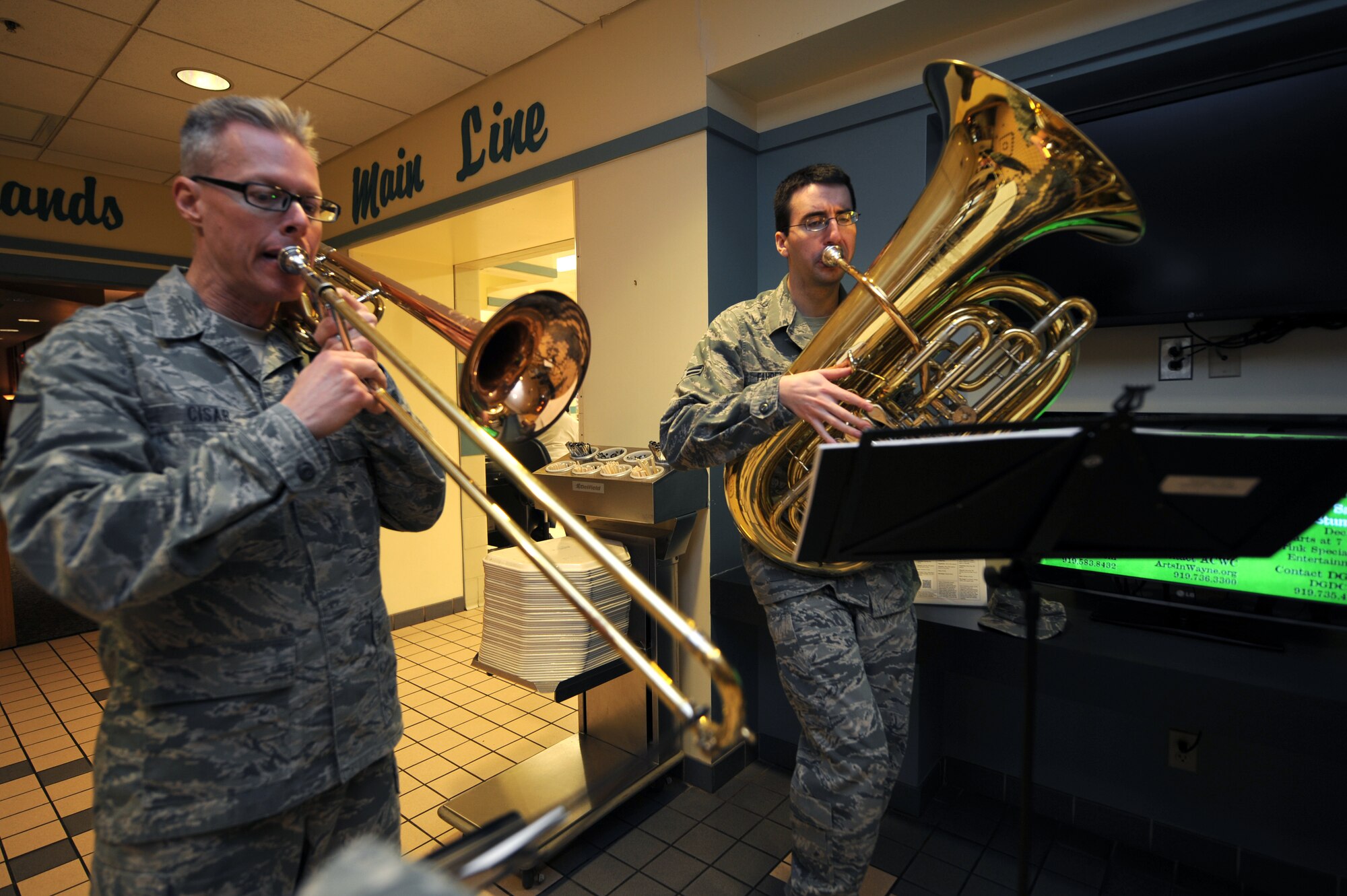 U.S. Air Force Master Sgt. John Cisar and Airman 1st Class Colby Fahrenbacher, USAF Heritage of America Band members, play holiday tunes at the Southern Eagle Dining Facility on Seymour Johnson Air Force Base, N.C., Dec. 12, 2012. The quartet played a variety of holiday music for members of Team Seymour during lunch hours. (U.S. Air Force photo/Airman 1st Class Aubrey White/Released)