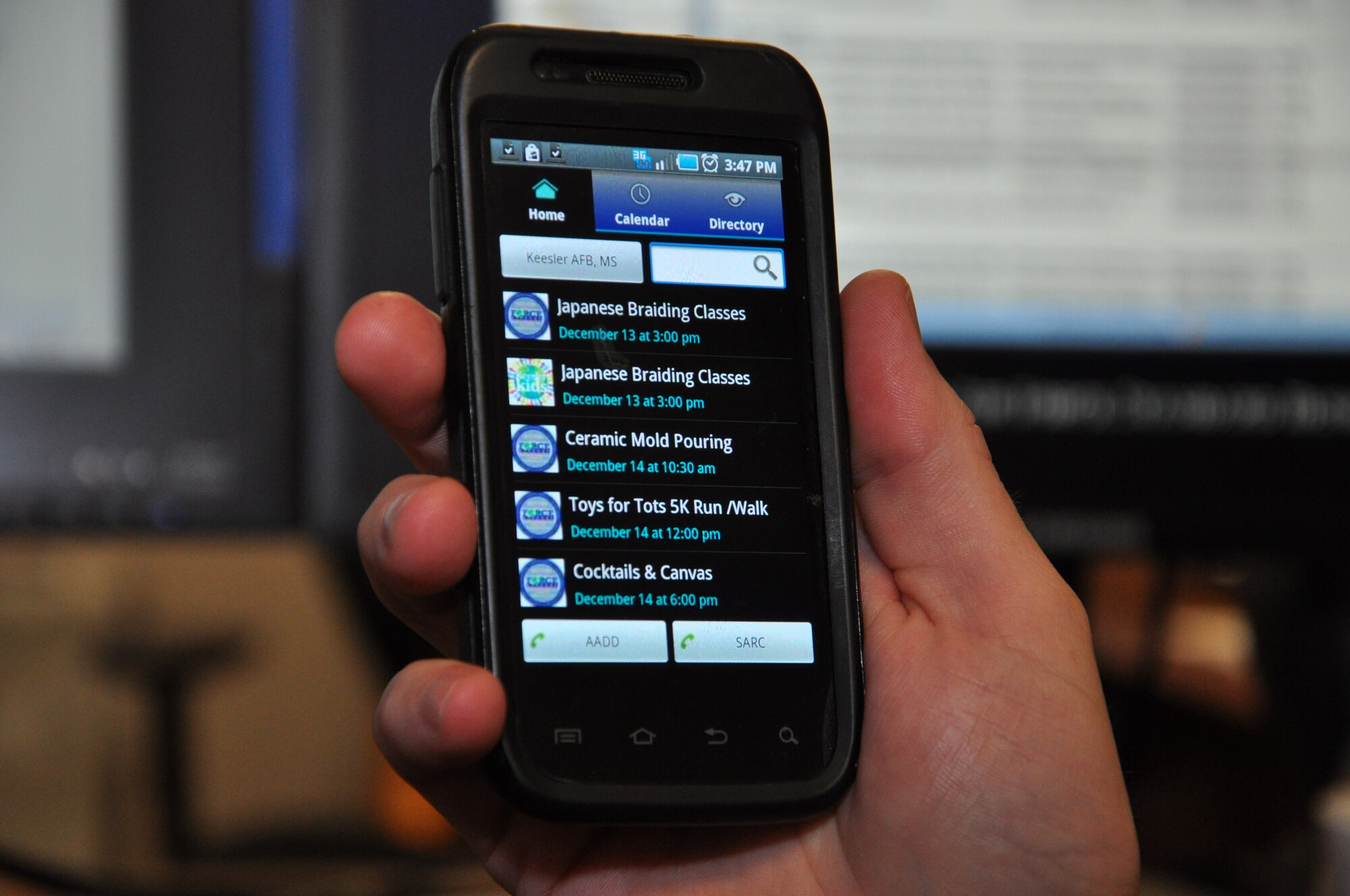 A My Military Communities app user scrolls through the list of events for Keesler Air Force Base, Miss., Dec. 12, 2012. The MyMC2 app provides mobile device users with a consolidated list of events and activities from multiple Keesler Facebook pages.  (U.S. Air Force photo by Staff Sgt. Eric Summers Jr.) 