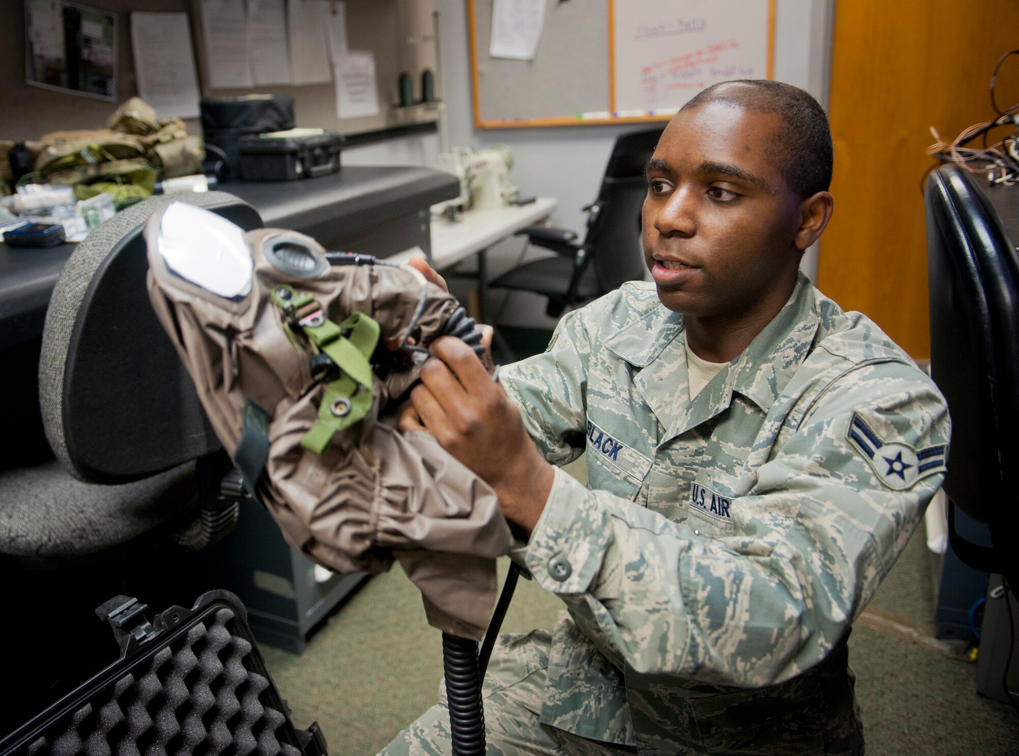 U.S. Air Force Airman 1st Class Mitchell Black, 347th Operations Support Squadron aircrew flight equipment (AFE) technician, inspects an aircrew gas mask at Moody Air Force Base, Ga., Dec. 6, 2012. Aircrew members use special gas masks that allow them to maintain communications with the rest of the aircrew. (U.S. Air Force photo by Airman 1st Class Jarrod Grammel/Released)
